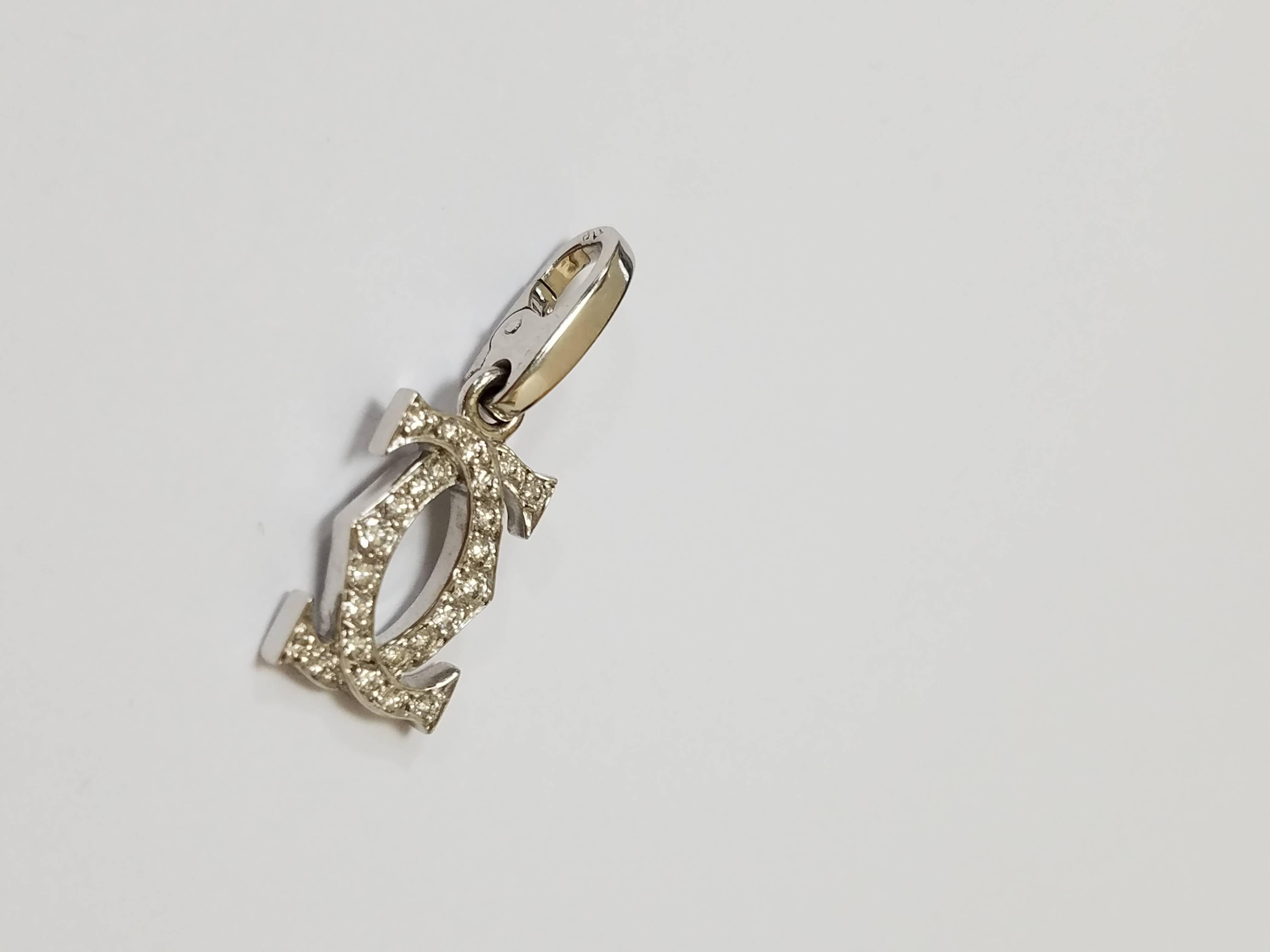 From the Double C collection, this white gold and diamond Cartier pendant is a great addition to a white gold chain. Measuring 1 inch, it contains 24 diamonds and weighs 2.3 grams. It is crafted in 18kt white gold and the diamonds are loupe clean