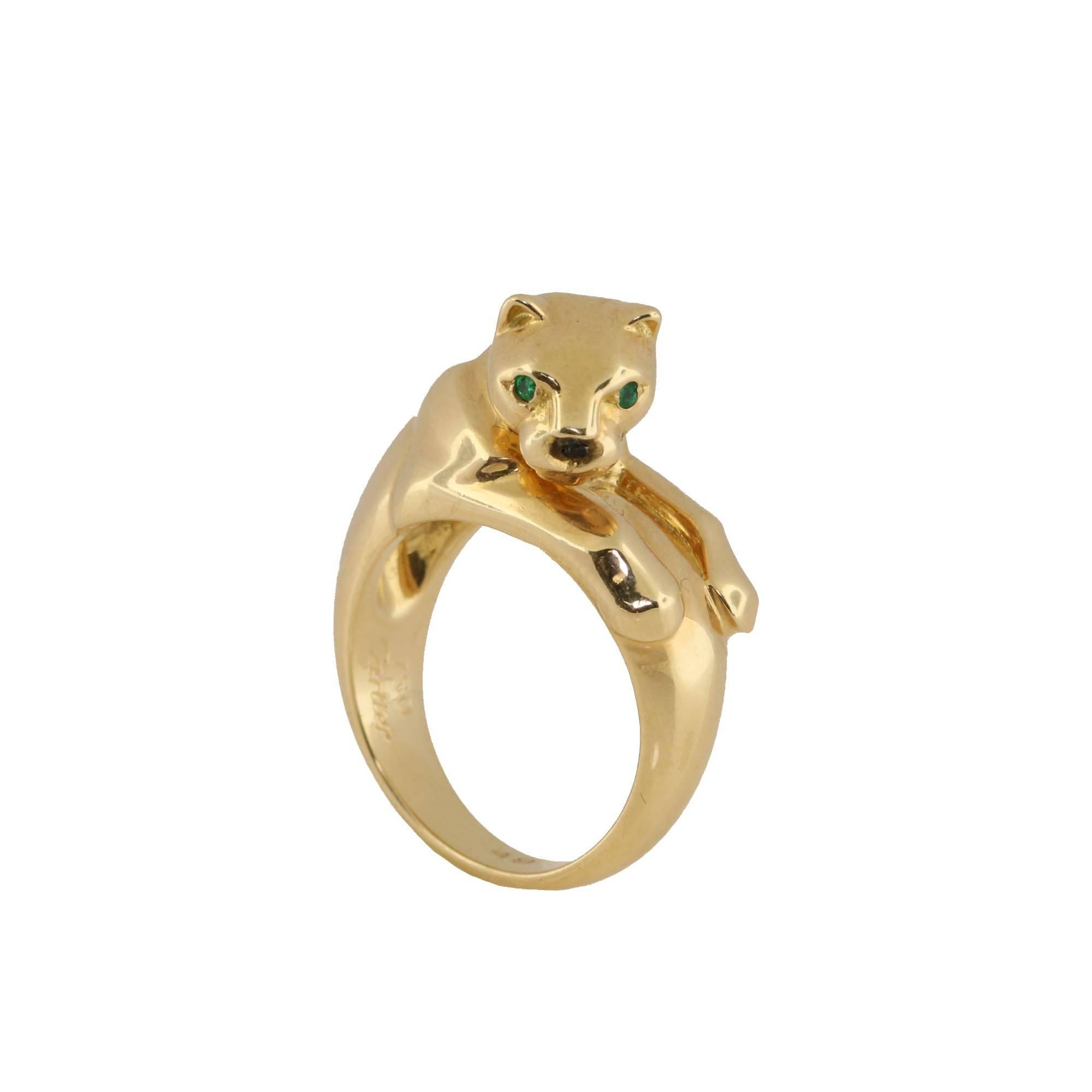Perfect ring for the Cartier lover in your life. Nothing says Cartier like the panther. This 18kt yellow gold ring is a size 4 3/4 which makes it an excellent pinky ring. The eyes on the panther are 2 natural green emeralds. 

It can also be sized