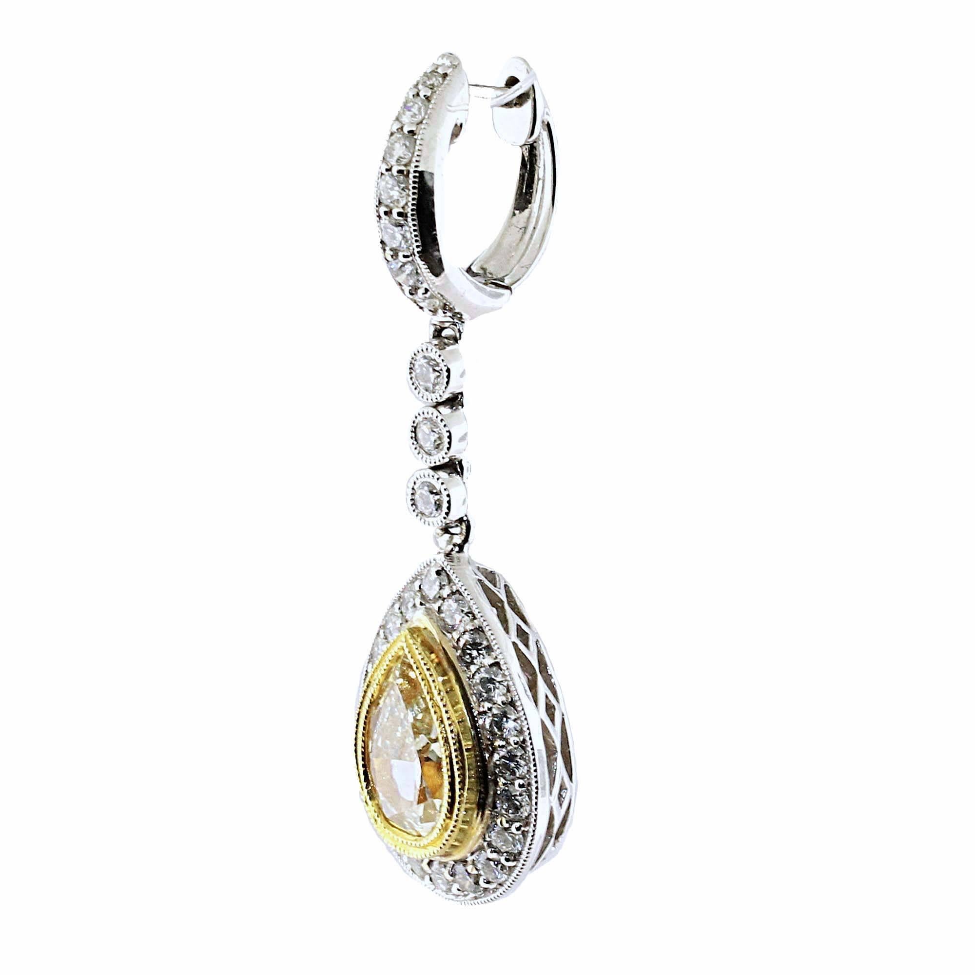 Spectacular long white and yellow diamond drop earrings. All these diamonds combine together to create this gorgeous pair of earrings. Wear them to a fancy event, or with jeans and a T-Shirt. 

2 Pear Shapes are yellow diamonds weighing
