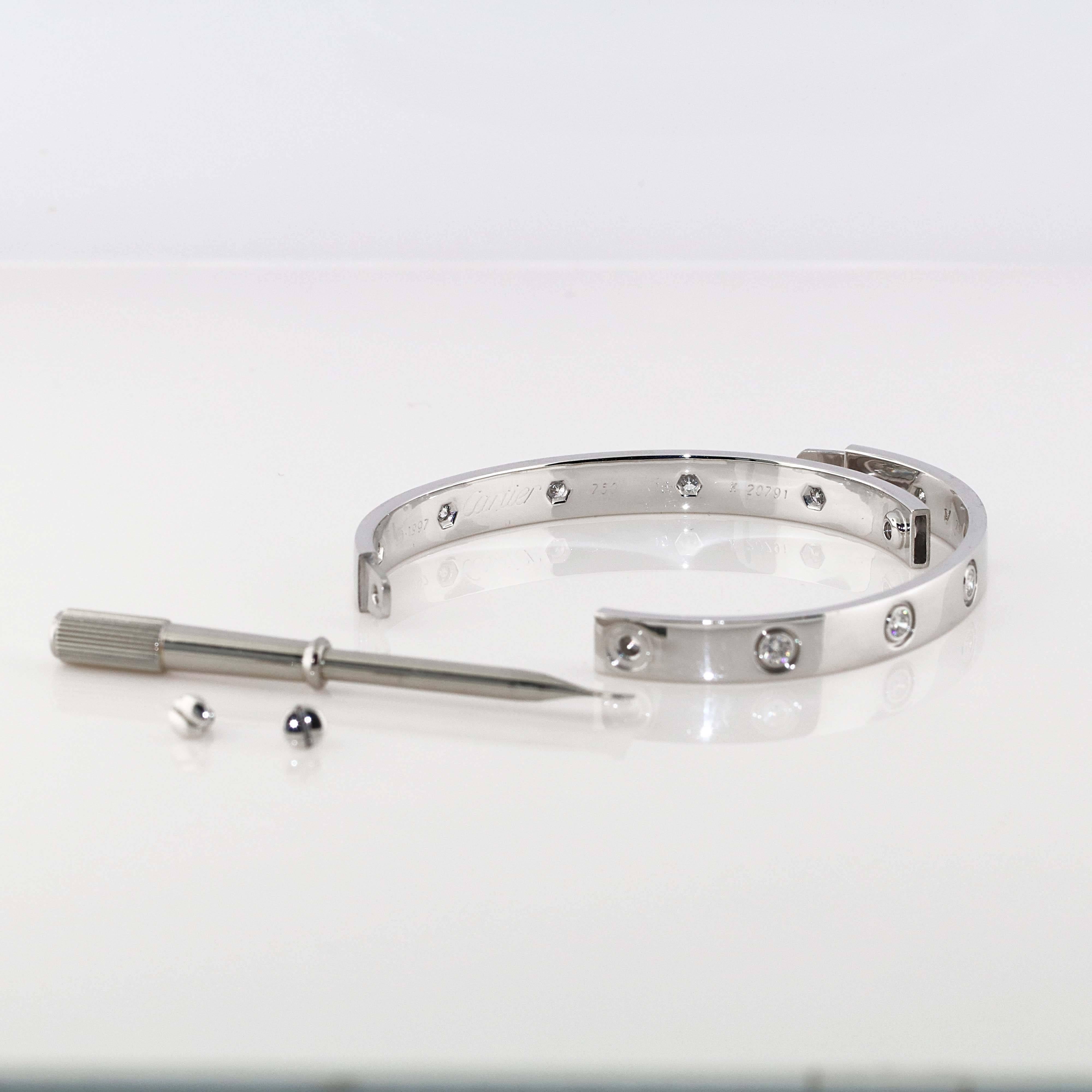 This iconic and timeless bracelet from Cartier's Love collection is finely crafted in 18k white gold and set with 10 brilliant-cut round diamonds. The diamonds are F-G Color and VS in clarity. This bangle is the size 16 model. 

Made in France