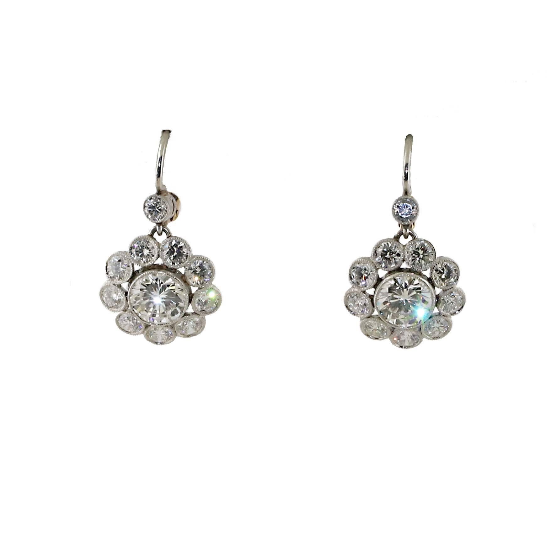 Get the deco look without paying the high price for an antique pair of earrings. This exceptional pair of diamond earrings has almost 5 carats of white diamonds set in both 18kt yellow and white gold. 

Each center stone is over 1 carat in size