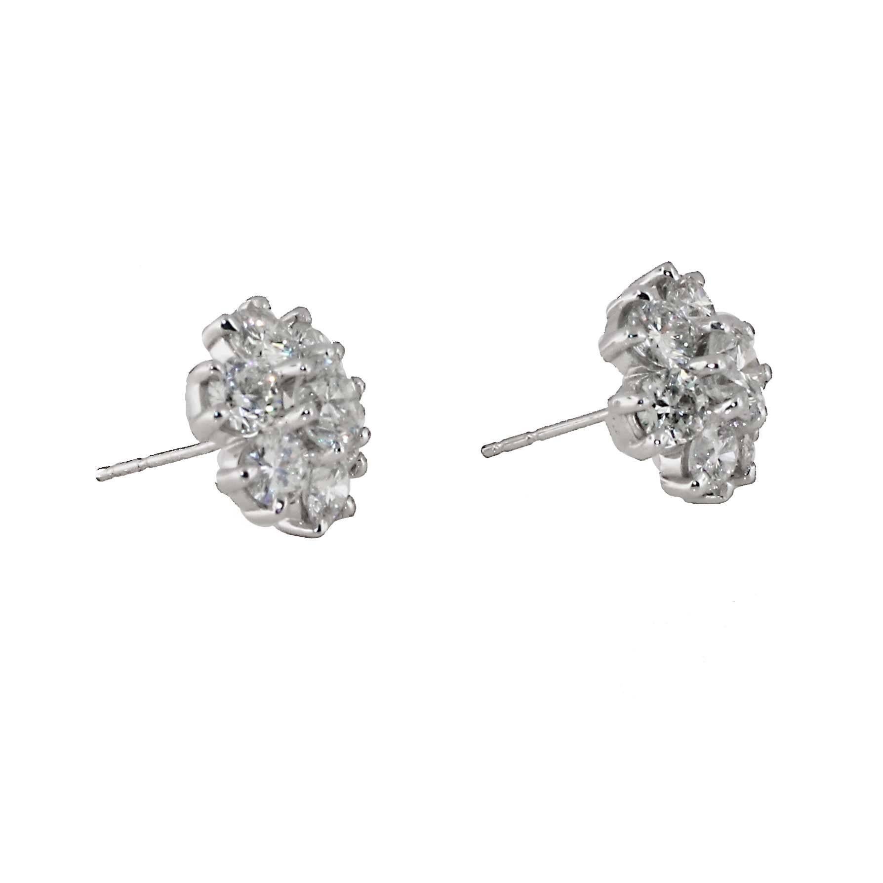 Great pair of diamond cluster earrings. Each earrings has 8 diamonds set in 14kt white gold. The total between the two pairs is approximately 4 carats of white diamonds. Gorgeous look as these sit right on the ear. 

(Center stones are larger than