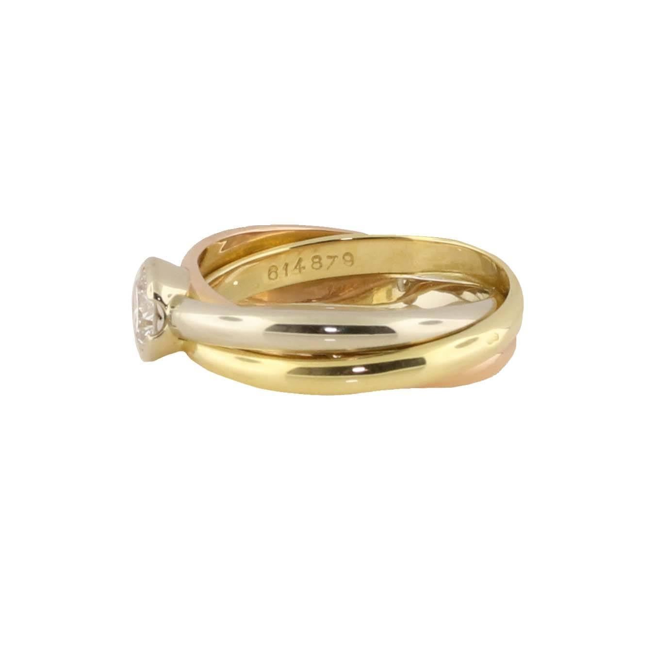 This ring is the definition of Cartier. It is classy, elegant and a true image of Cartier's fashion. This tri-colored rolling ring has the normal white, yellow and rose gold bands interlocking but is also adorned with a solitaire diamond. The size