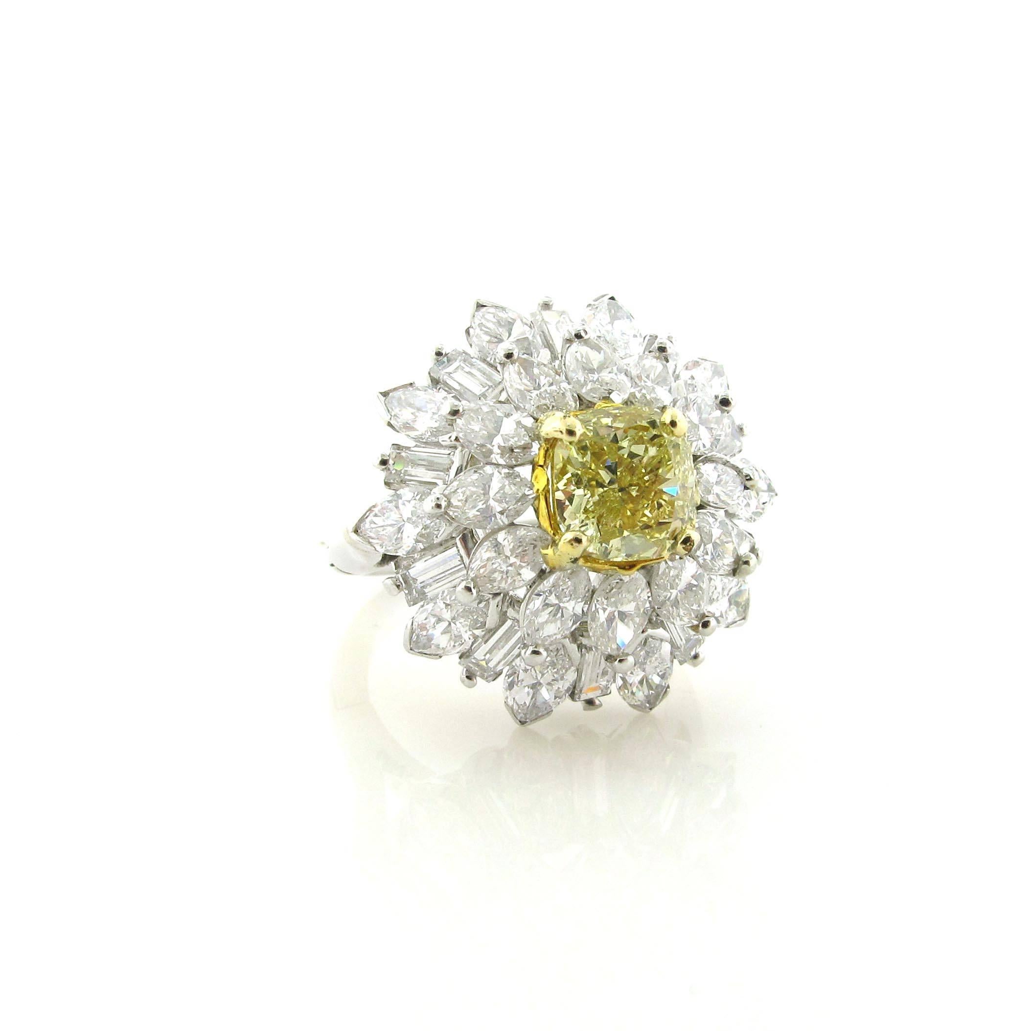 Gorgeous 1.64 carat Fancy Light Yellow Cushion diamond with GIA certificate. The center yellow diamond is surrounded by approximately 6 carats of fancy cut white diamonds. This ring will look great as either an everyday ring or dressed up for