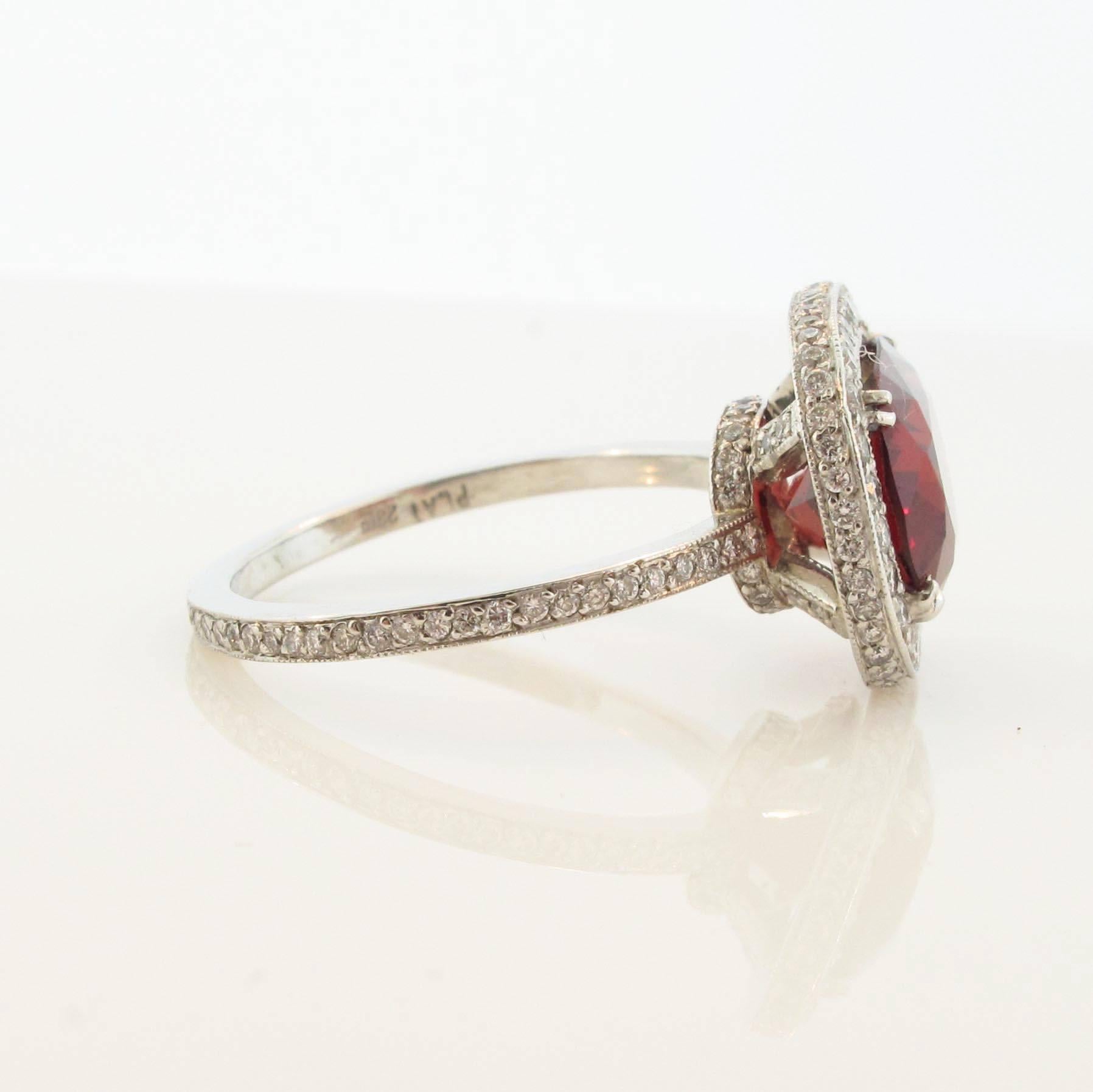 A spectacular diamond, and Spinel platinum ring. The 3.40 carat Spinel is the optimum deep red color one would desire in a ring like this. This easy to wear ring can be dressed up or dressed down for any occasion. The band has pave diamonds on both