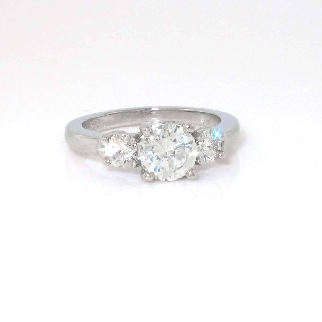 This is the greatest value in engagement rings. A .95ct white diamond center stone with approximately .34ct of white diamond side stones. The colors of the 3 stones match perfectly and the clarity is eye clean. This is a great ring and it looks even
