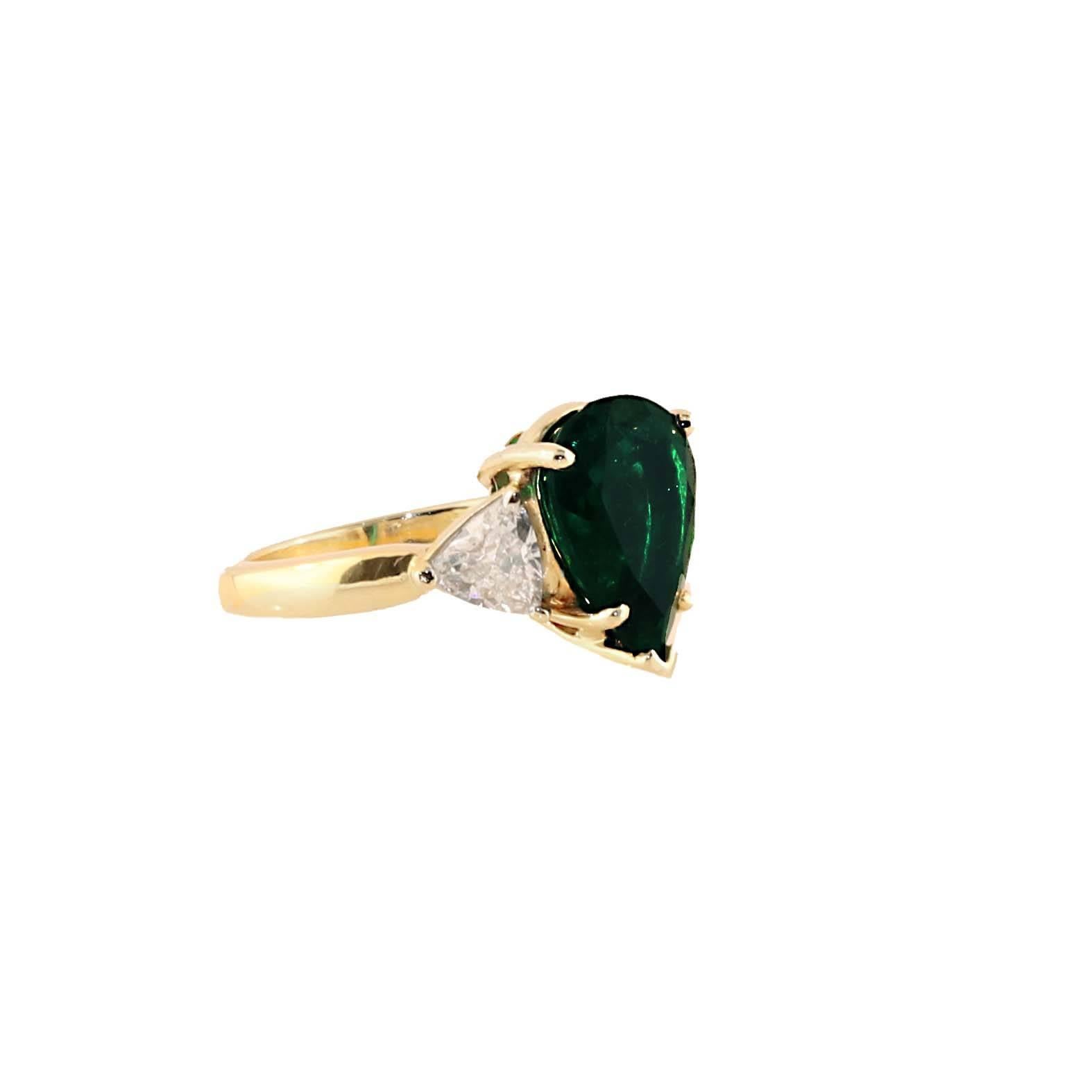 The ideal pear shape emerald. This deep green color is the perfect color for an emerald. Set next to you gorgeous white diamonds weighing a total of 1.20 carats this ring is definitely special. The ring can be sized up or down with no problem. Just