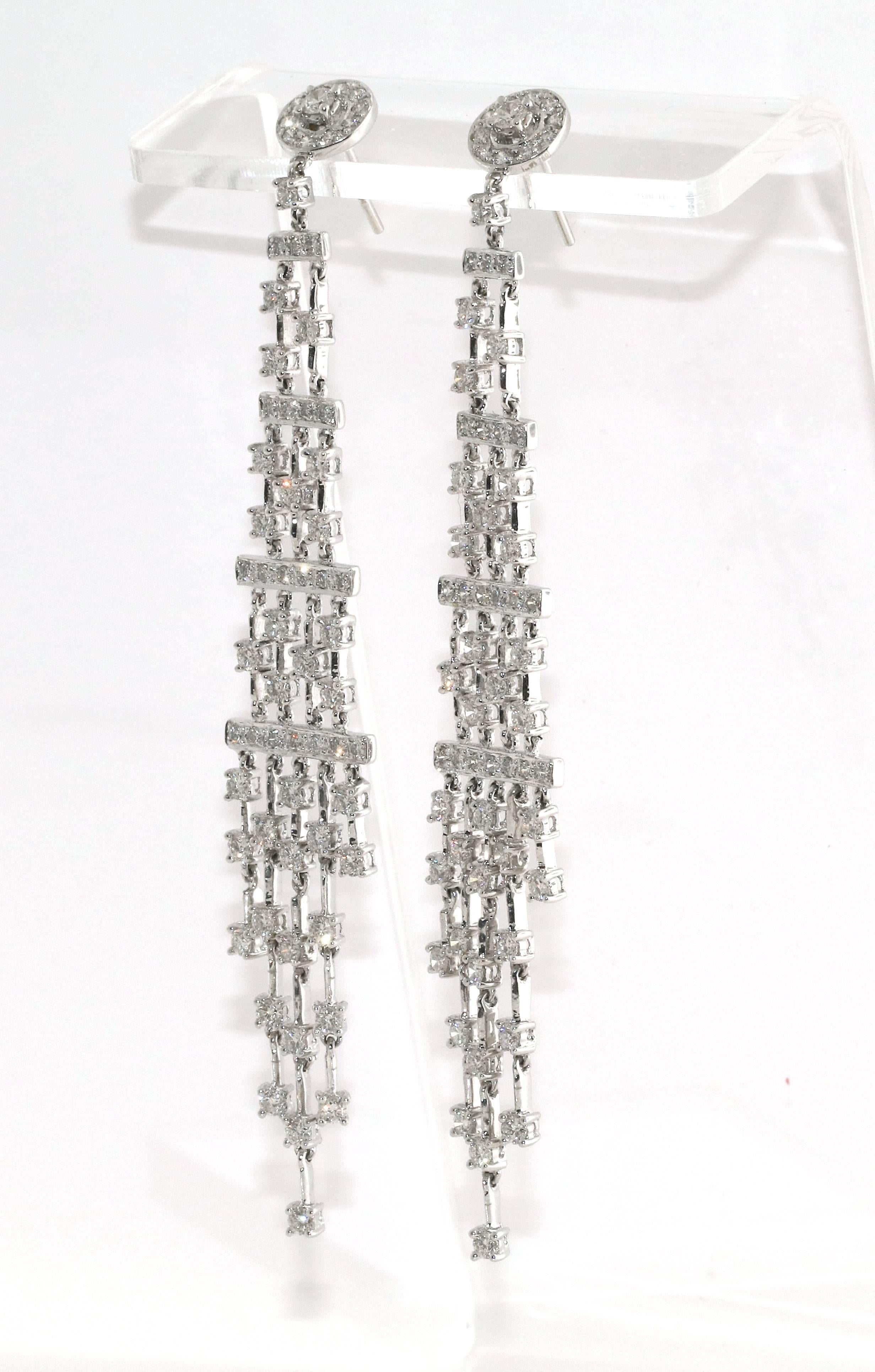 Over 100 diamonds adorn this gorgeous pair of chandelier style dangle earrings. Each column of diamonds moves individually giving it a very unique look. This also allows them to sparkle much more than if they were still.  There are approximately