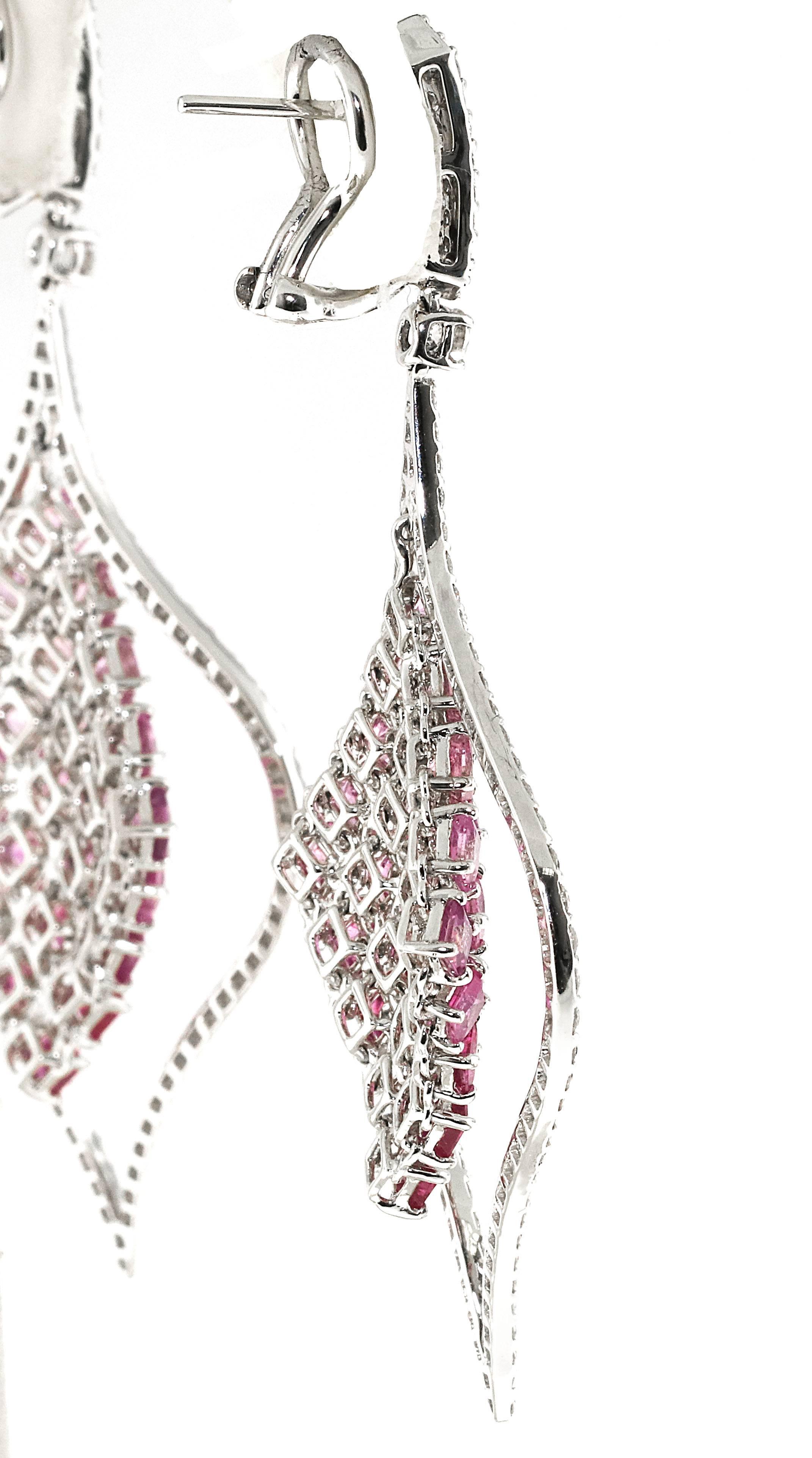 Gorgeous pair of hanging pink sapphire and diamond drop earrings. The greatest part is how perfectly the pink sapphires graduate in color from deep pink to light pink. The center section of the earrings hangs freely so there is flexible movement.