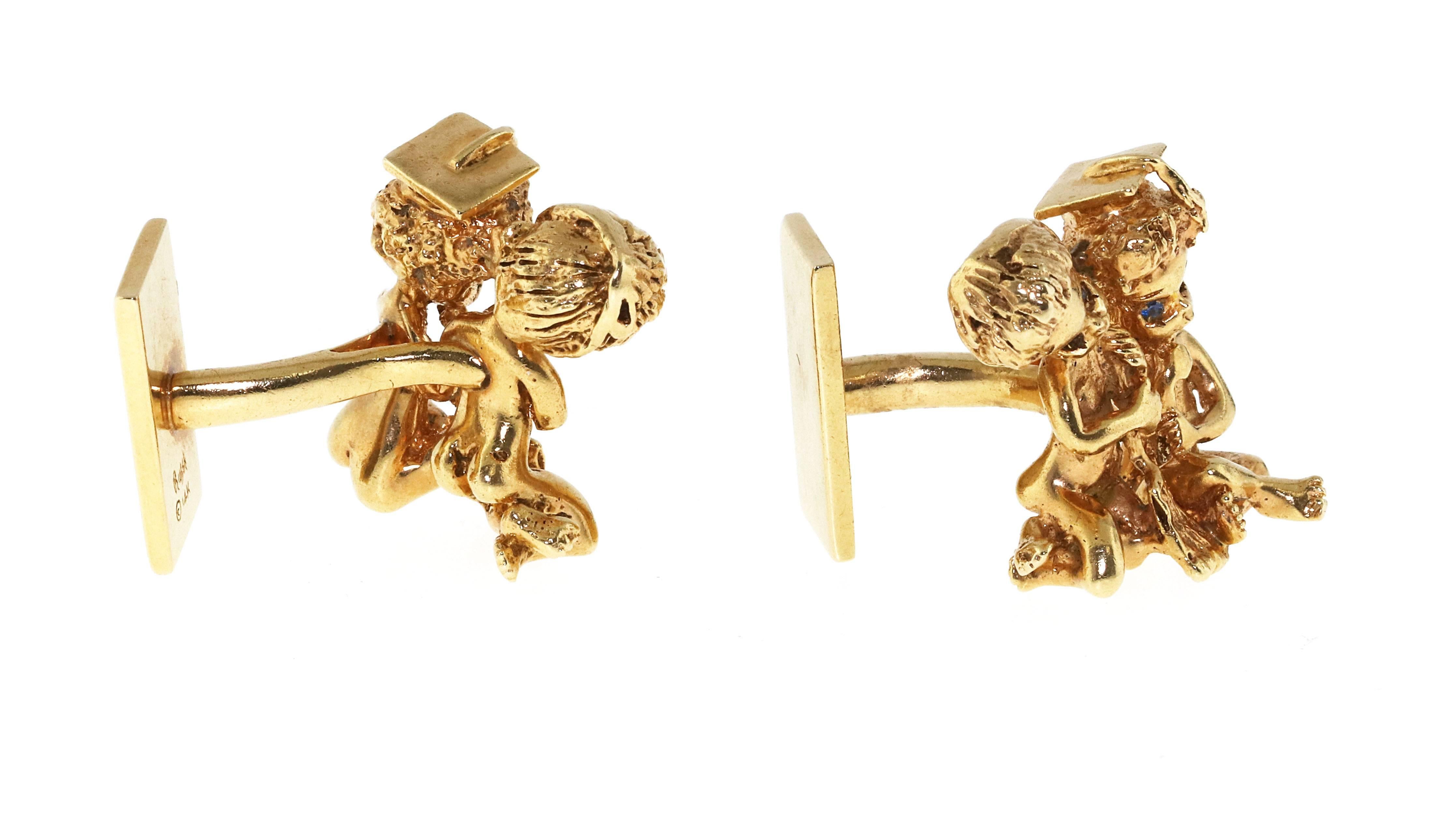 Pair of William Ruser cufflinks meticulously crafted from 14 karat yellow gold. The famous American designer is know for his charming angel motif jewelry. The cufflinks are a matched pair, each with 2 “Ruser Angels”. The angels have blue sapphire