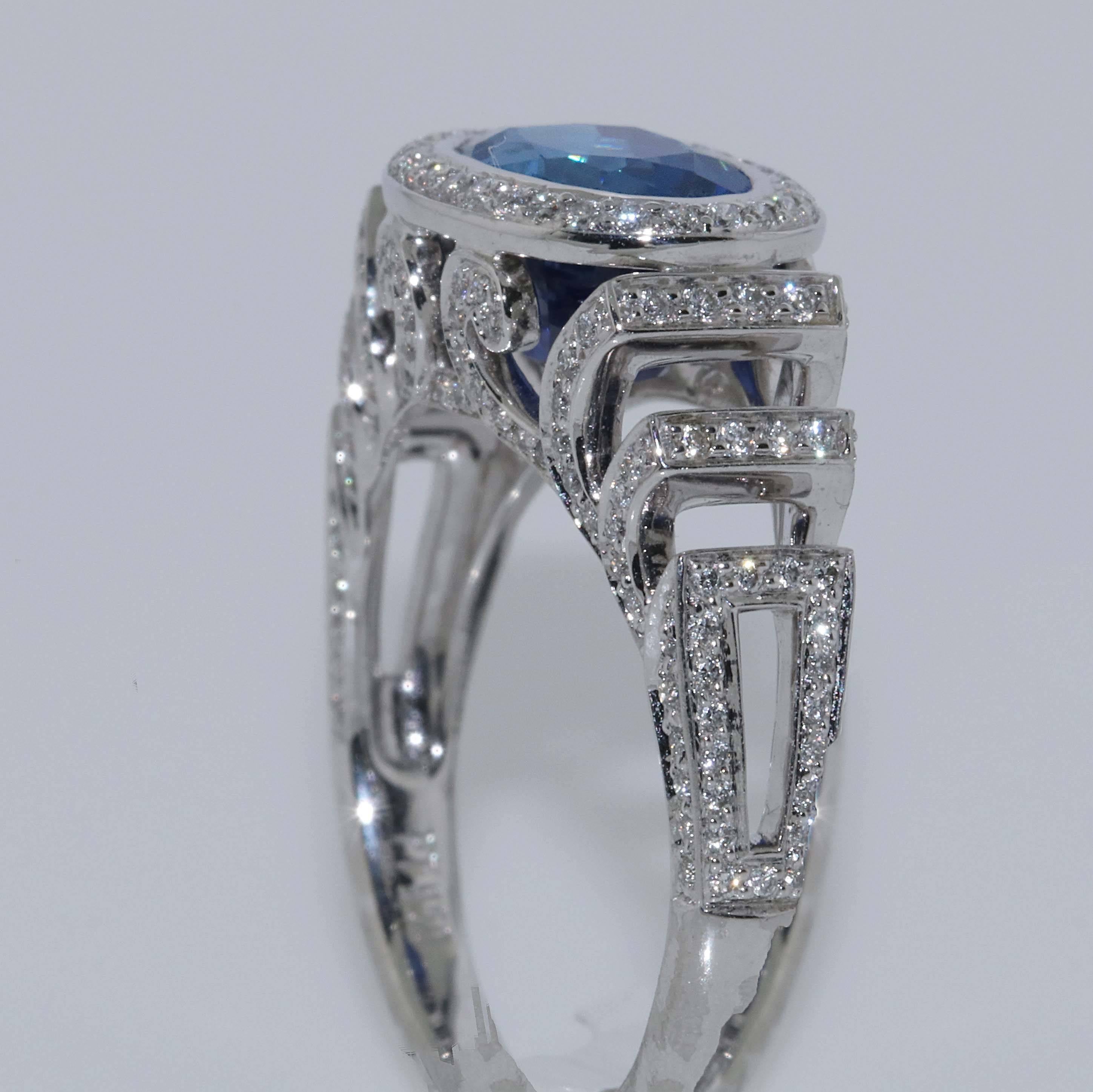 AGTA Certified 3.54 carat Burma No Heat blue sapphire and diamond modern ring. The oval blue sapphire is sitting east-west. The AGTA certificate shows there is no clarity enhancements and the color is completely natural. The diamond ring has 0.46