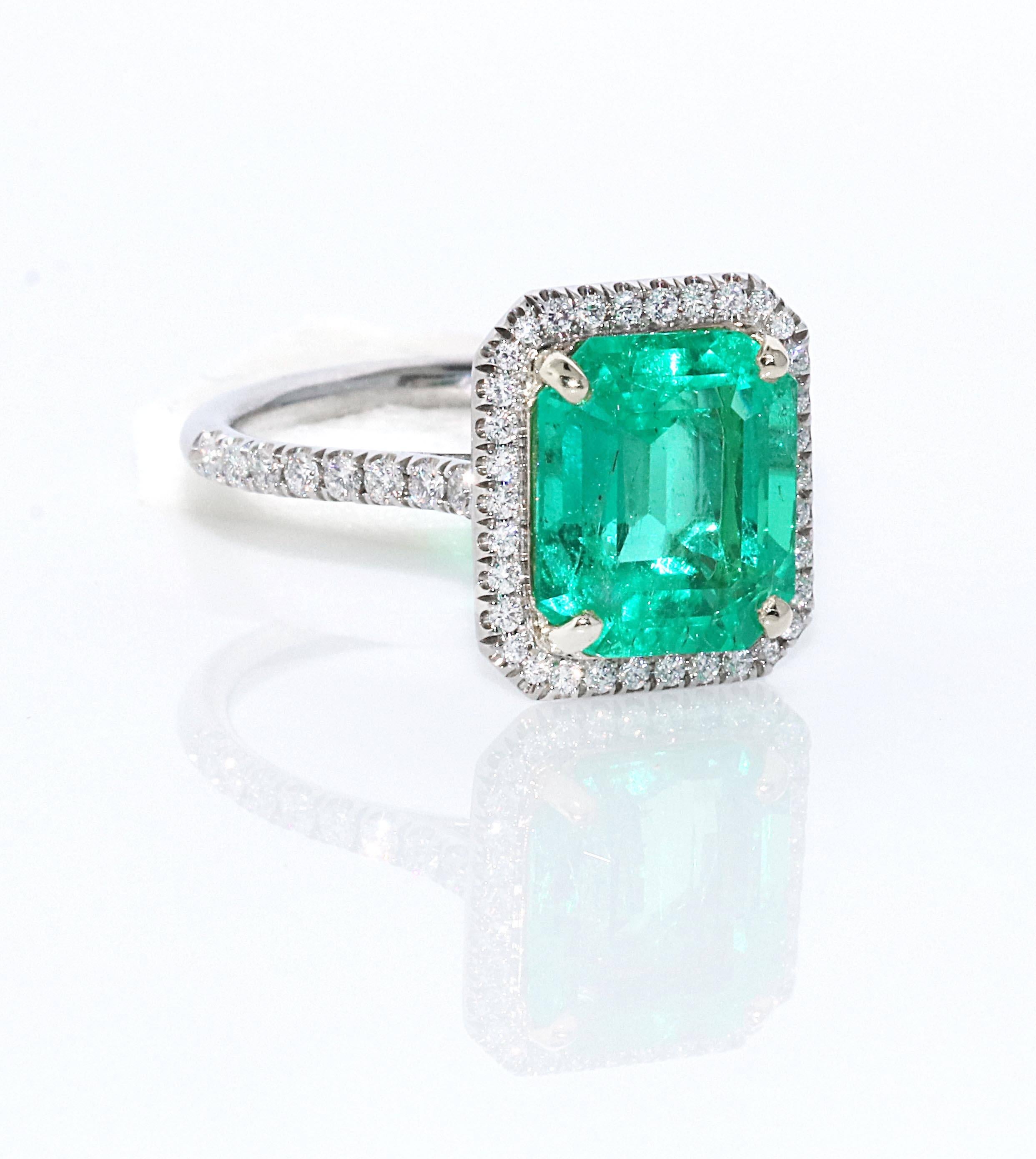 The most gorgeous bright green colored emerald cut emerald. This center emerald has a GIA certificate stating Colombian with minor enhancements. This means the stone is of the highest caliber of quality. Very few inclusions can be seen in the stone,