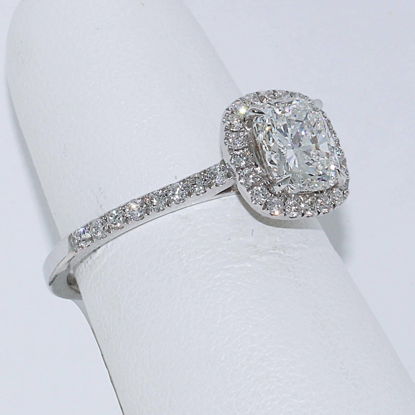 If you are looking to get engaged, this is the ideal ring for you. An ideal cut 1.21 G/VVS2 cushion cut diamond set in a gorgeous halo with a pave band. G color is in the near colorless category meaning the diamond will show bright white. VVS2 is
