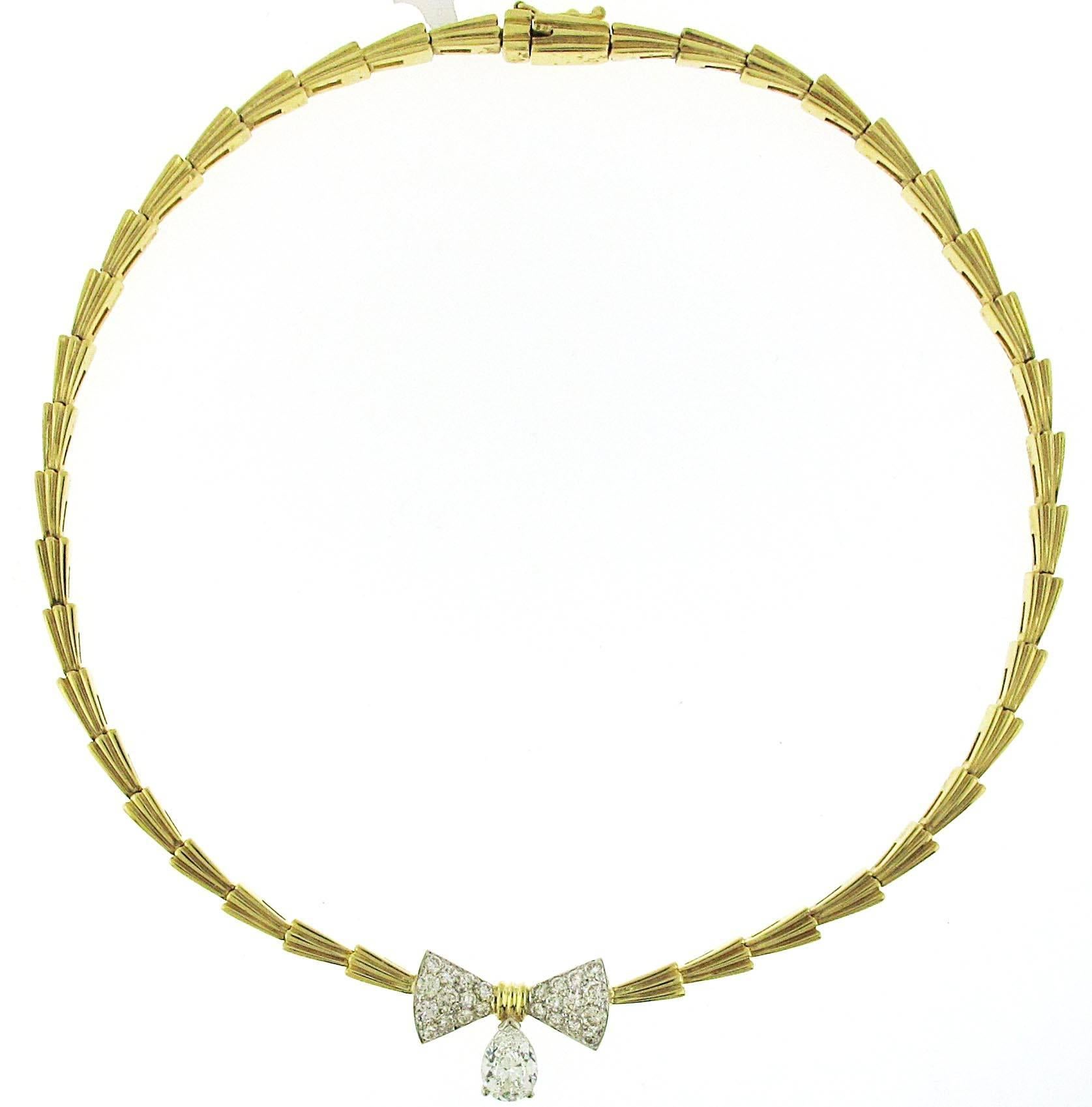 The perfect Valentine's Day necklace. This gorgeous 1.51 ct center stone is adorned with over 1 carat of fine white diamonds creating the bow shape. The necklace is 18kt yellow gold which is a must higher quality than a similar necklace in 14kt