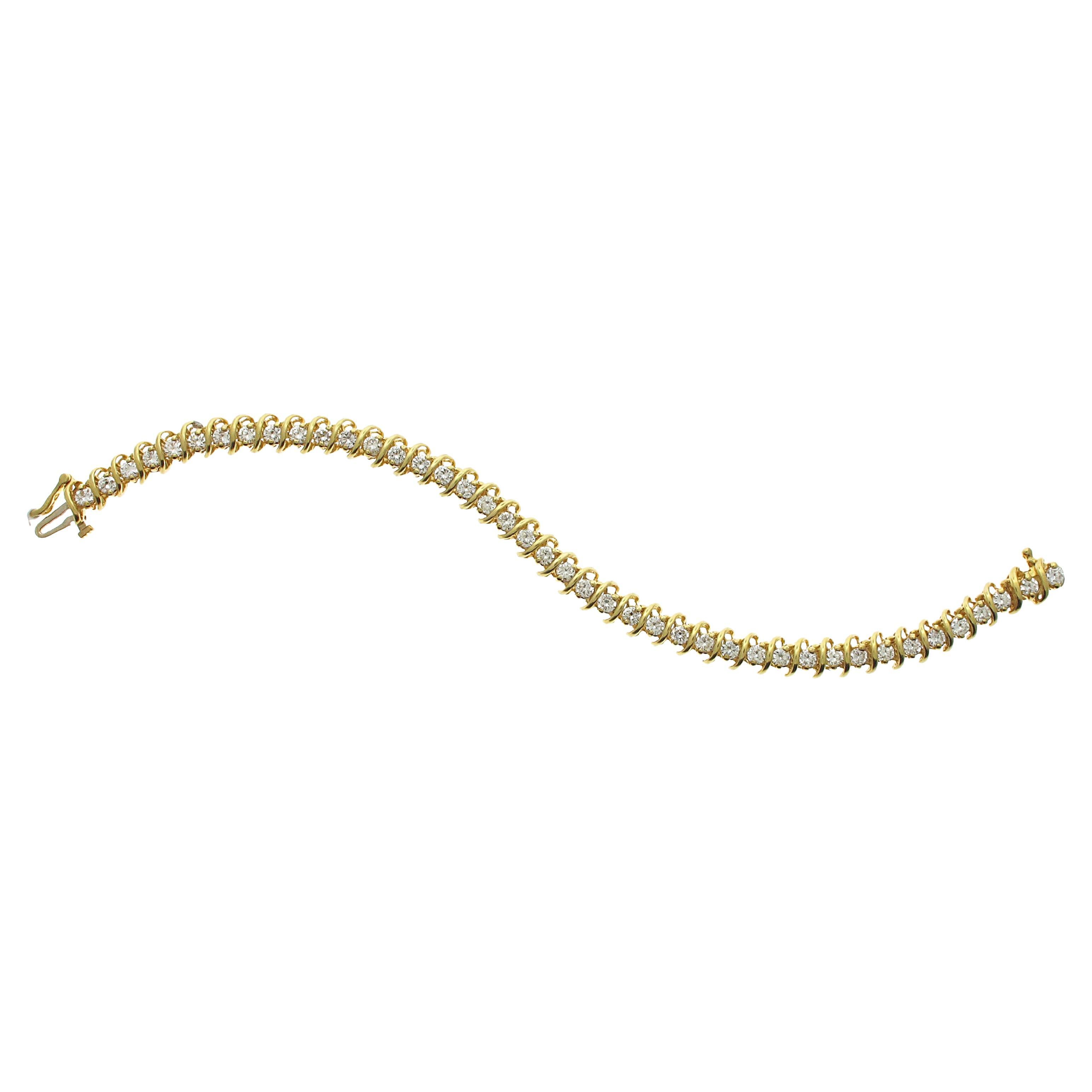 18 karat yellow gold diamond tennis bracelet with 42 white round brilliant diamonds weighing an estimated total of 5.50 carats. 

The bracelet measures 7.5 inches in length. 
