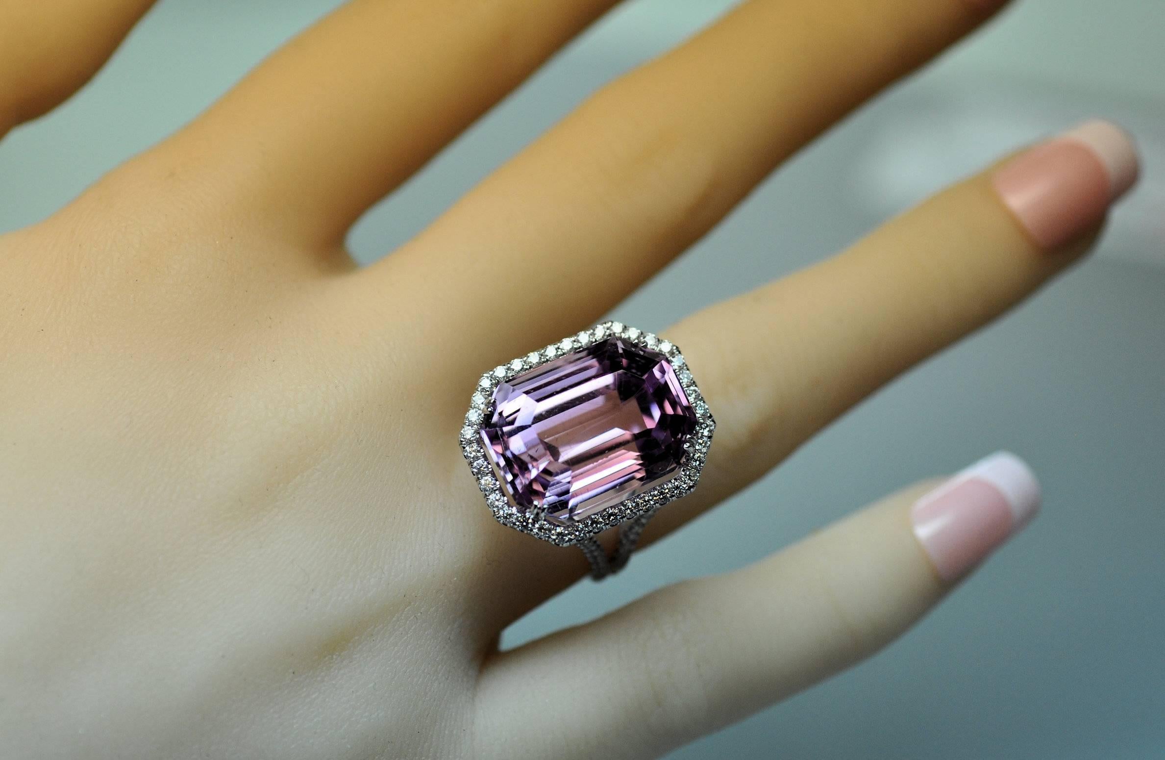 New custom, hand made ring in 18 Karat white gold set with emerald cut Kunzite gemstone. 
The Kunzite weighs approximately 25.40 carats and exhibits the lovely, rich pink with strong lavender overtones.  It glows!!
Accompanied by 110 round diamonds