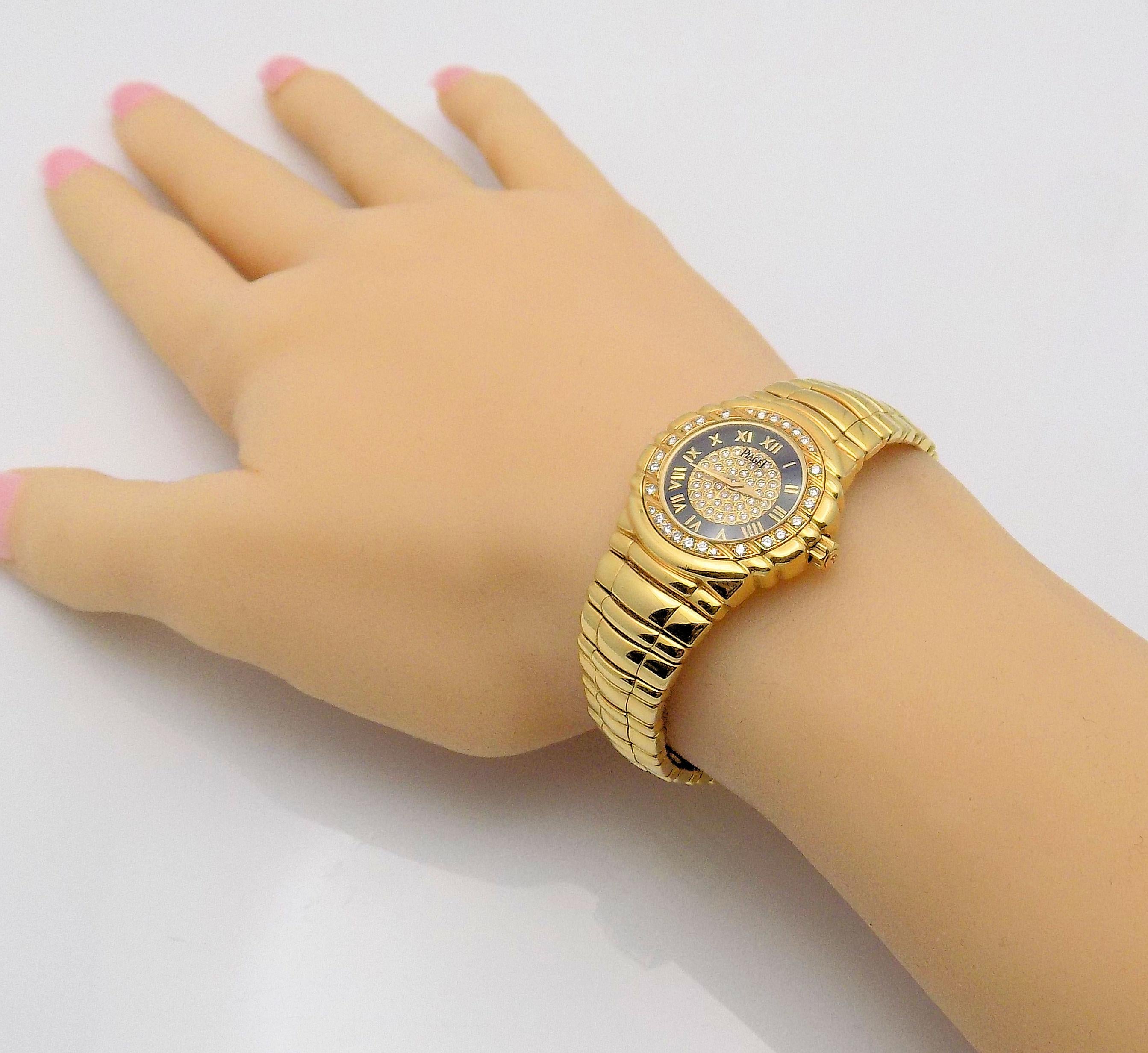Stunning 18 Karat Yellow Gold Lady's Piaget Tanagra Wristwatch with Black Face featuring 70 Round Brilliant Diamonds 0.35 Carat Total Weight, VS, G; with Box & Papers; Model: 16033.M.401.D; Serial #617922; Roman Numerals; 25 MM Case; 1997; Swiss