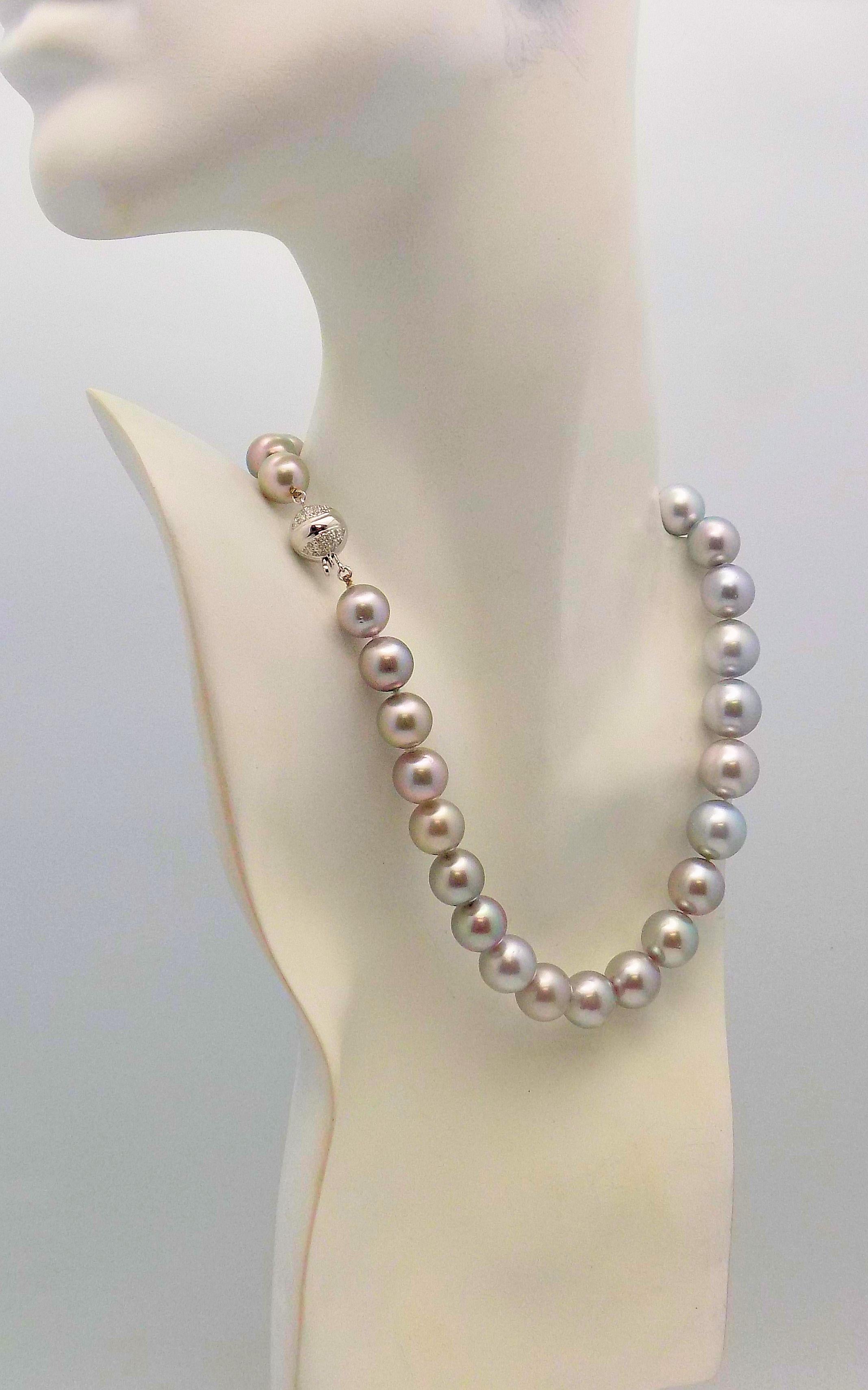 Stunning Strand of 31 Platinum South Sea Cultured Pearls Measuring 10.75 X 14.35 MM. Round, Very Light Blemishing.  18 Karat White Gold Clasp with 0.50 Carat Total Weight in Diamonds; SI, I. 16” Length.