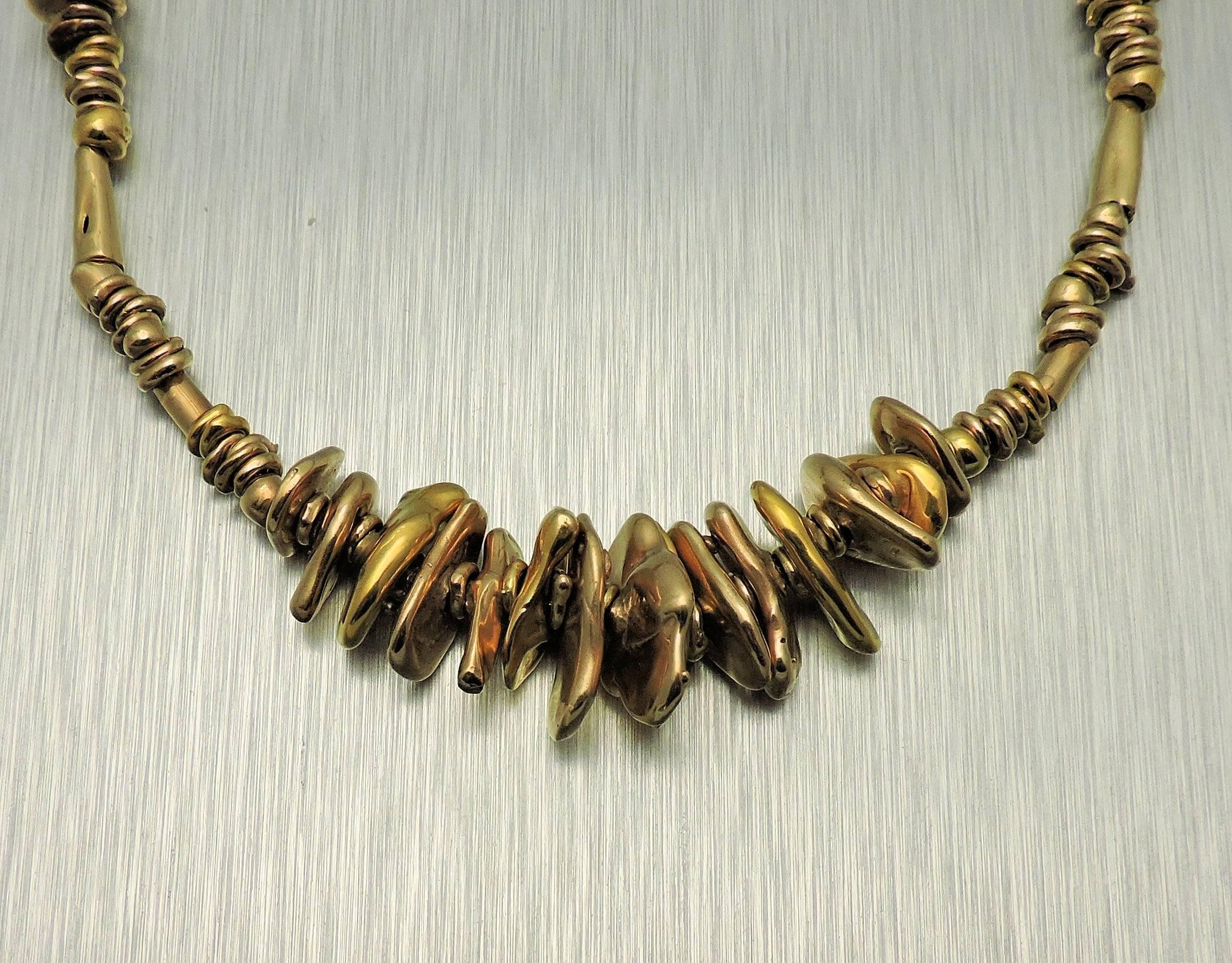 14K yellow gold, one-of-a-kind necklace made by noted Texas artist, Velma Davis Dozier, exhibited in 1964 and published.  This piece is a series of flattened free-form discs separated by spirals and tubed of gold.  Mrs. Dozier was a Dallas