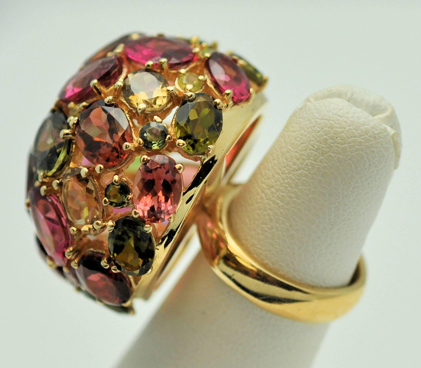 Large and Lovely 18K prong set domed colored stone ring.  Contains 40 round and oval tourmalines, amethysts, citrines weighing 20.00 cts. total weight. A treat!!  Finger size is small but can easily be sized. 