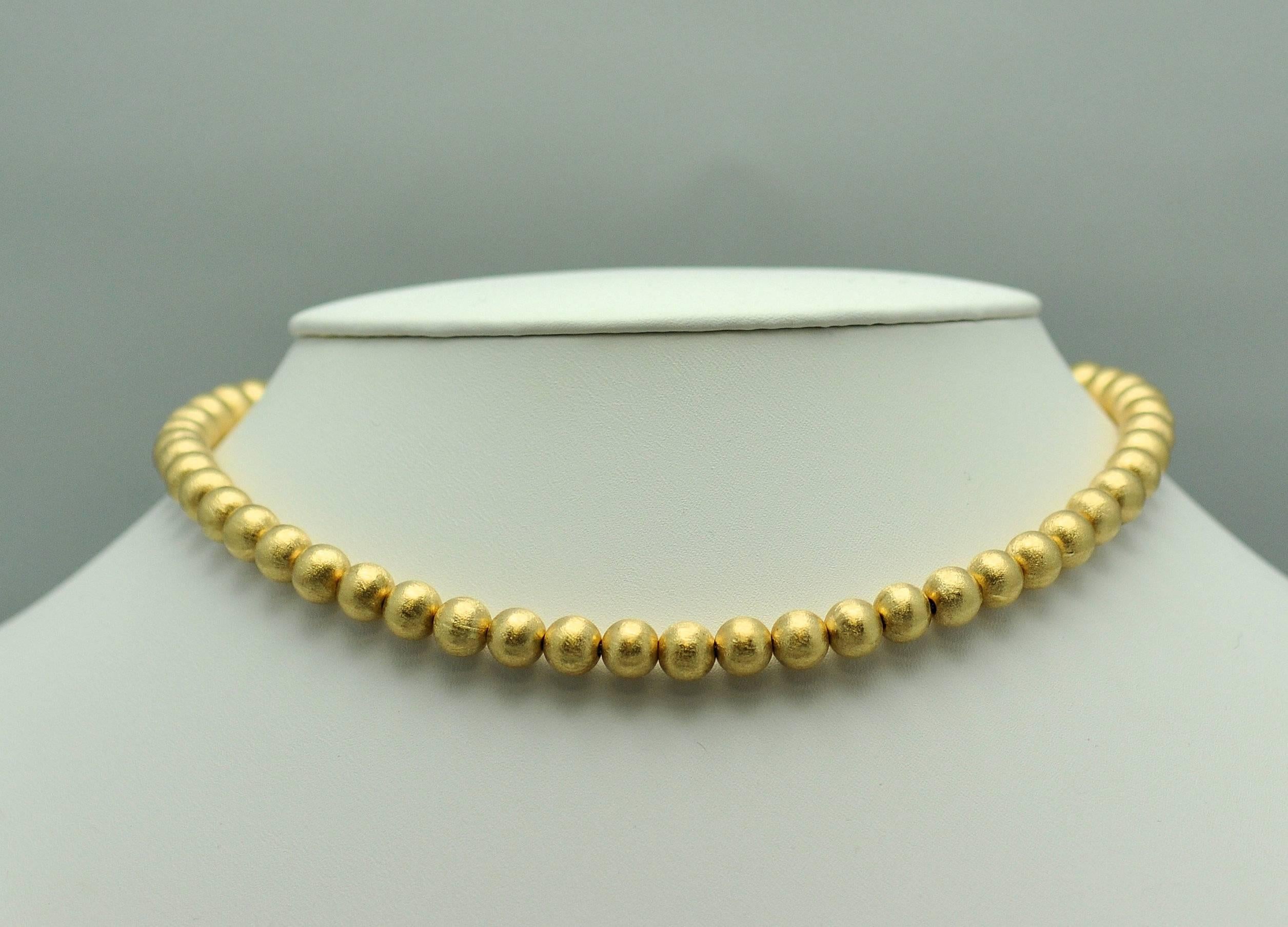 Lovely strand of 14K yellow gold Florentine finish beads.  These are made with thick walled beads for a higher quality than is made today, and they are strung on foxtail chain.  Spring ring clasp. Beautiful finish. 8 mm. beads, 16 in. 26 gr. 