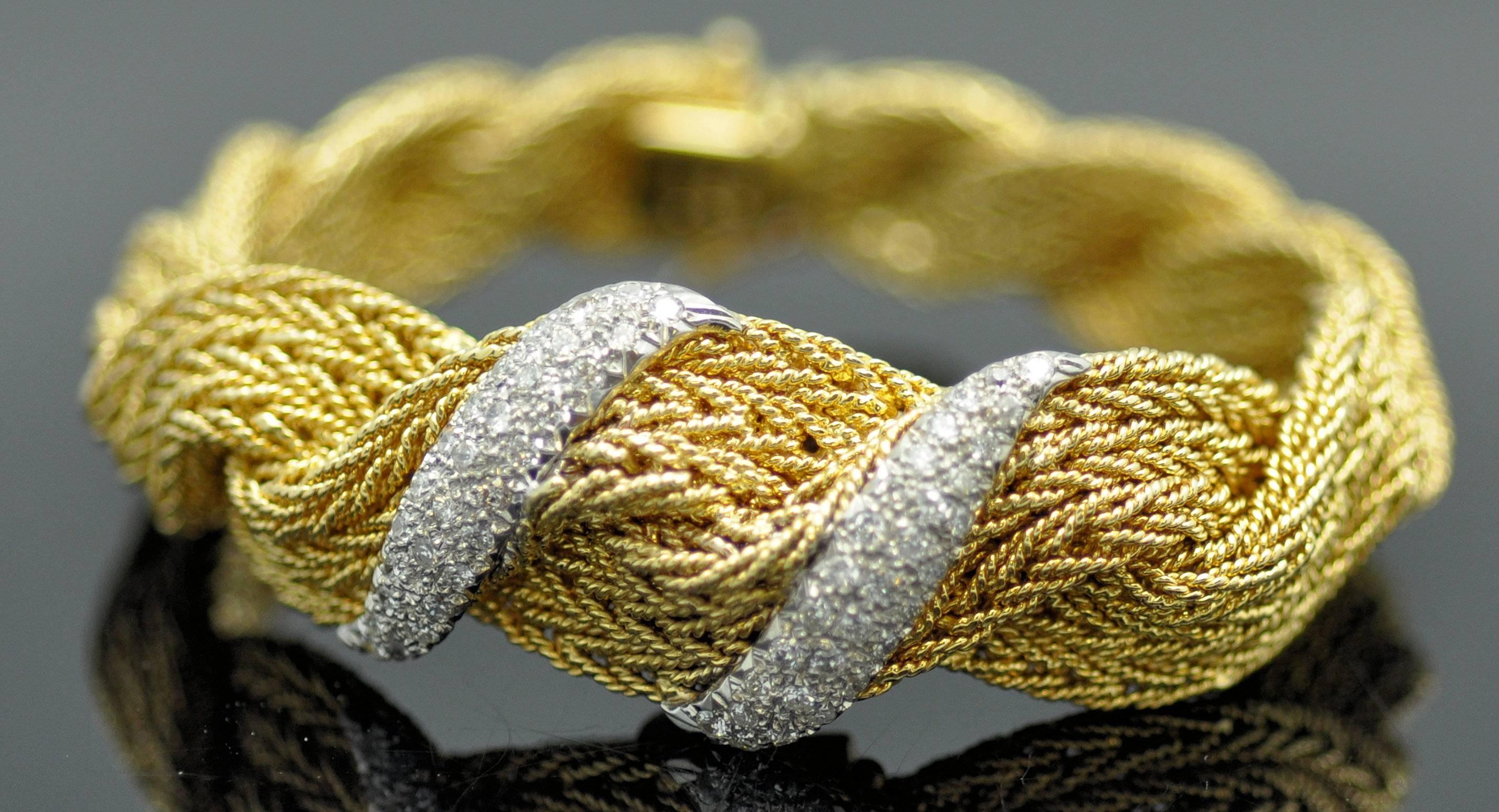 18K yellow gold woven bracelet wrist watch.  Hinged diamond set cover conceals the watch.  The bracelet is graduated, wider at the top and narrows at the back.  No one creates gold pieces like the Italians, masters of weaving it, almost like fabric.