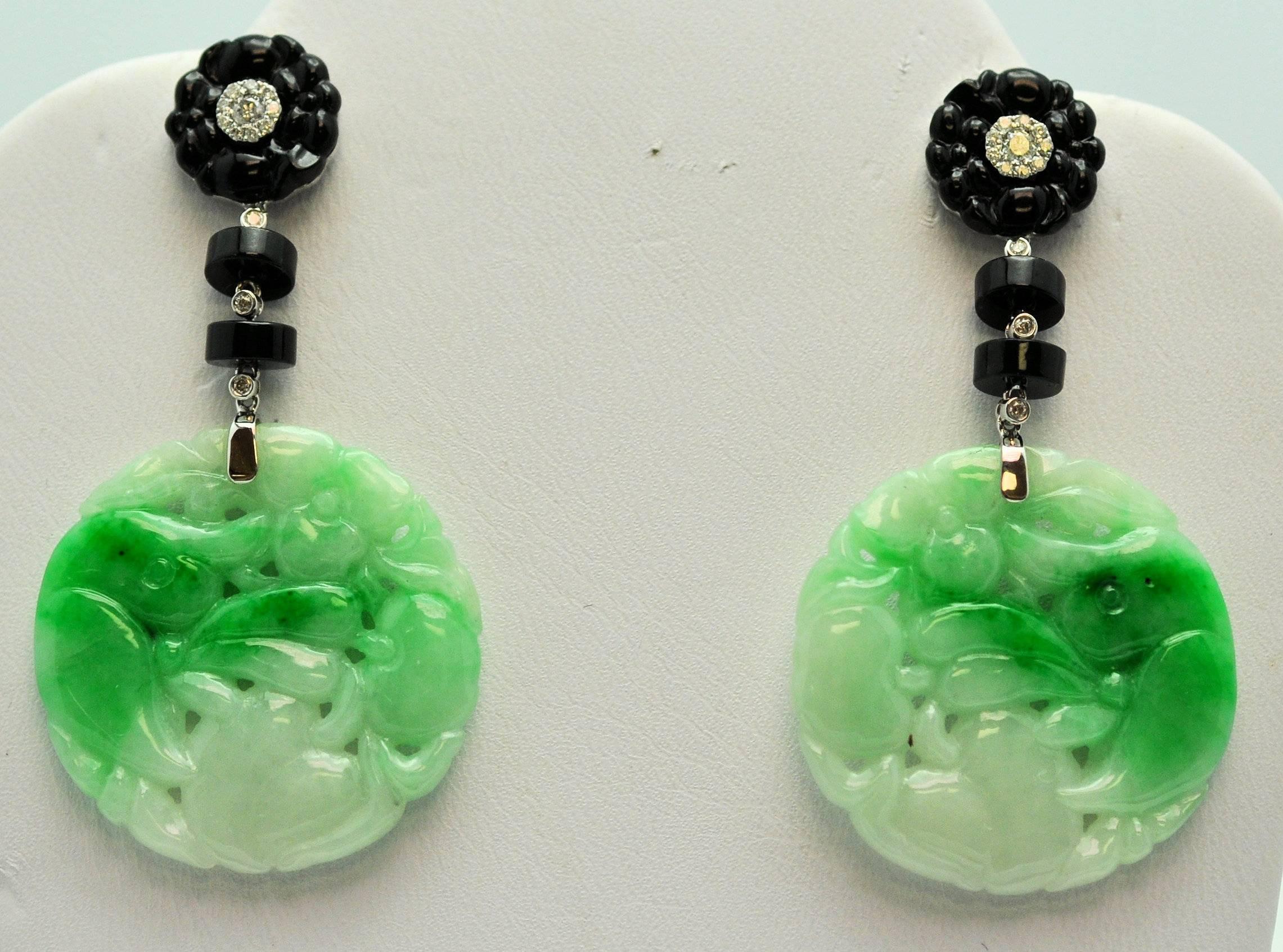 Dramatic, Statement Pendant earrings of finely carved jadeite jade in mottled green to white.  18K white gold with floral carved top set with diamonds and drop in black onyx and diamond.  
Jade weighs 12.22 grams
Diamonds .22 ct. 
Gold 1.7 grams.