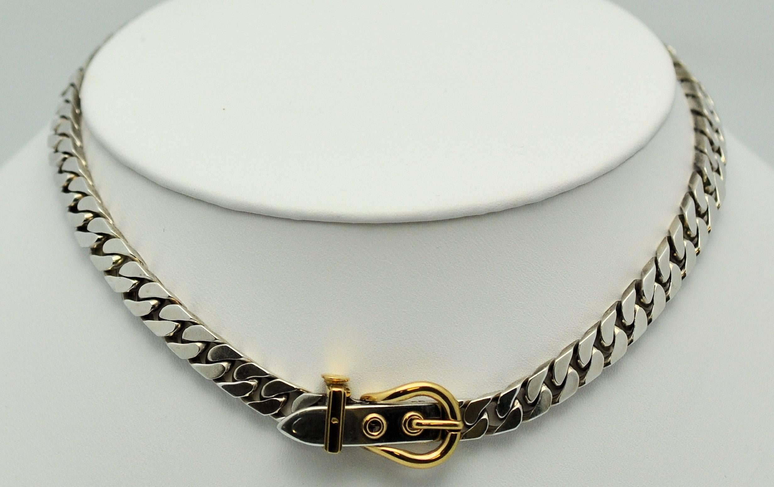 Sterling Silver and 18K yellow gold chain link necklace with buckle motif clasp by Hermes. Spring release clasp in very good working condition. All appropriate hallmarks and signature.  15.5 inches long. 