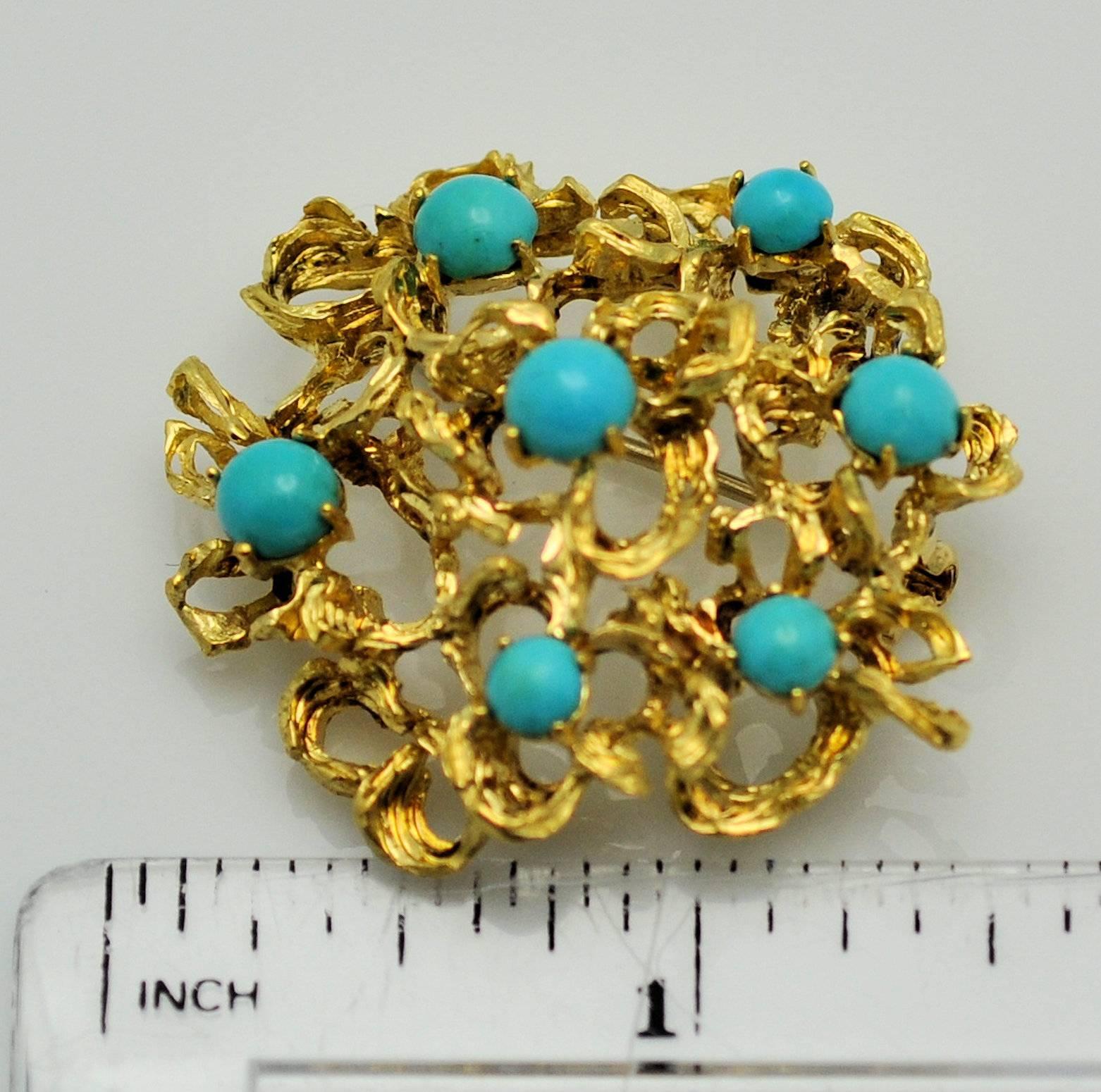 18K yellow gold free form brooch from Italy set with 7 round cabachons of fine turquoise.  Stones measure 4.5 x 5 mm.  Signed:  Italy 18K 