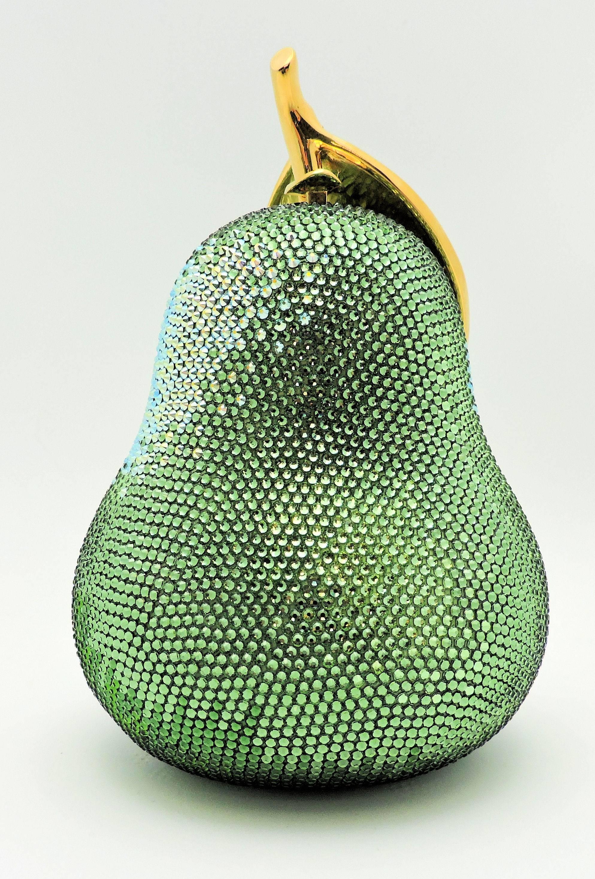 Immaculate condition Forelle Pear jeweled evening bag by Judith Leiber.  As is her style, the bag is not just the pear, but also has a large leaf overlapping.  Accompanied by mirror, coin purse, booklet and mirror pouch.  Hinged chain fitting so