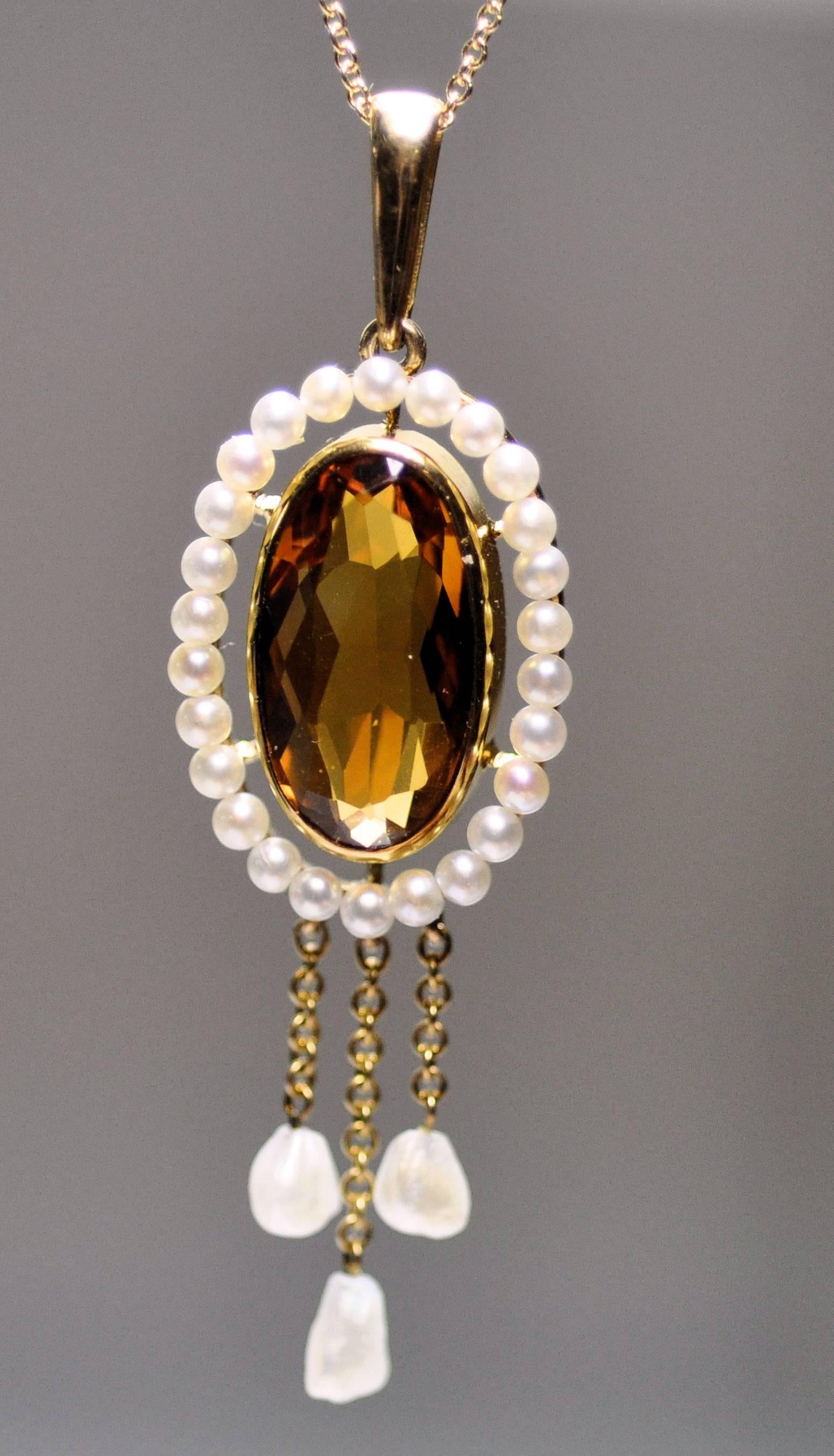 Antique lavaliere pendant with bezel set dark amber color citrine.  Measures 16 x 9 mm.  Surrounded by seed pearls 2 mm. and three pendants of gold chain and American Mississippi River fresh water pearls.  14K yellow gold cable chain 18 inches long.