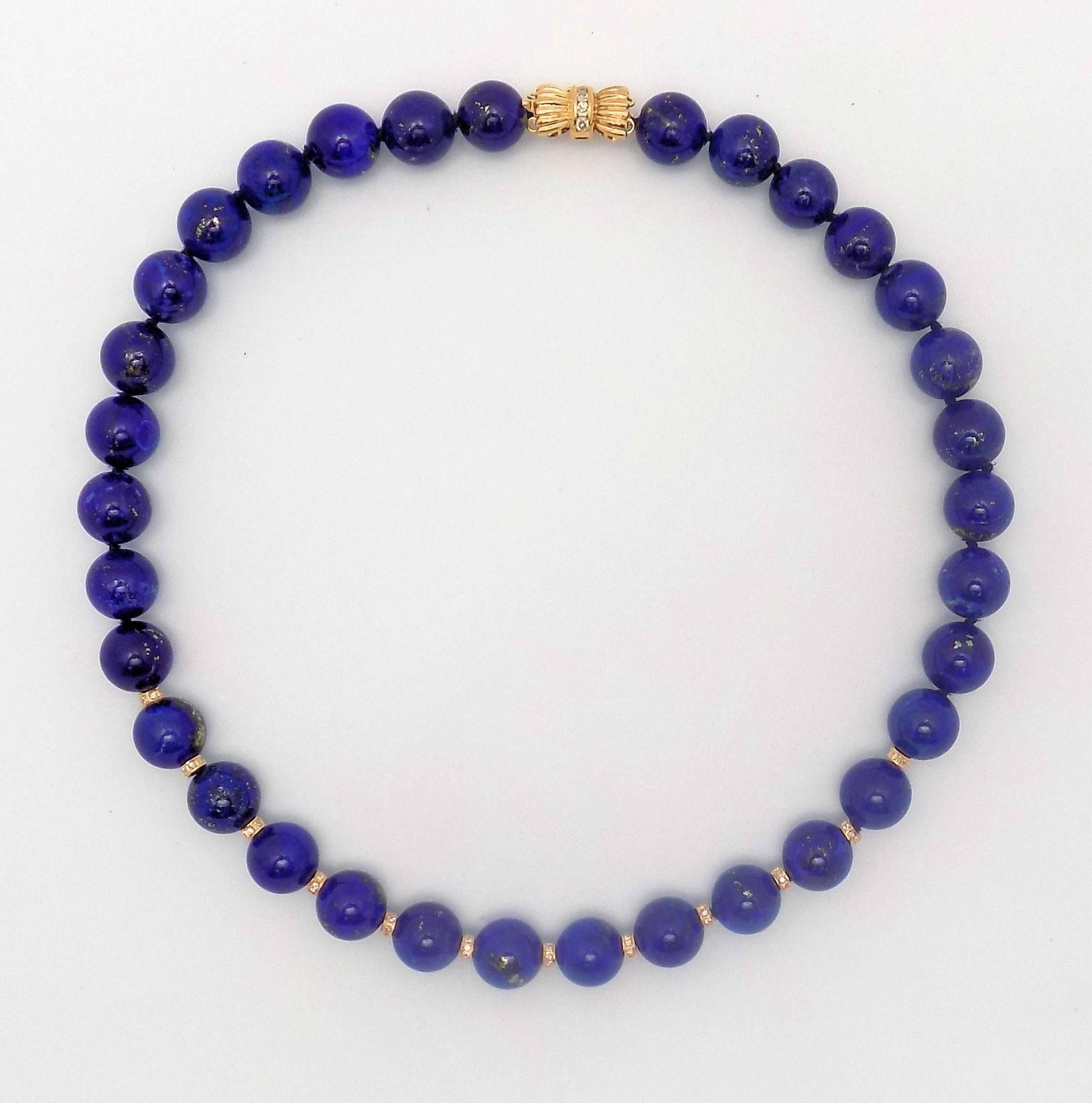 A very fine strand of uniform large size lapis lazuli beads measuring 12 mm.  There are 33 beads, spaced in the front with twelve diamond-set rondelles.  Clasp also contains diamonds.  Yellow gold 14 Karat, 0.75 carat. total weight in round diamonds
