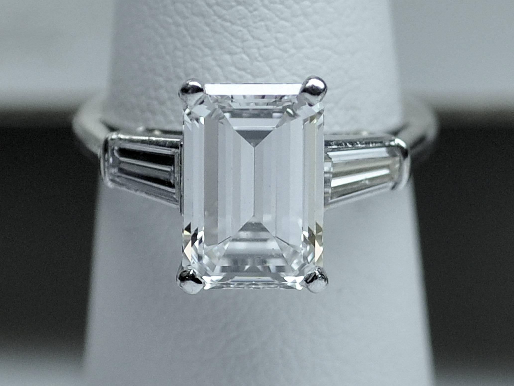 A platinum engagement ring in the classic design of center stone and tapered baguette cut diamonds on the sides.  This lovely 3.25 carat emerald cut diamond is  beautifully cut with maximum brilliance.  GIA report: G color, VS-1 clarity, very good,