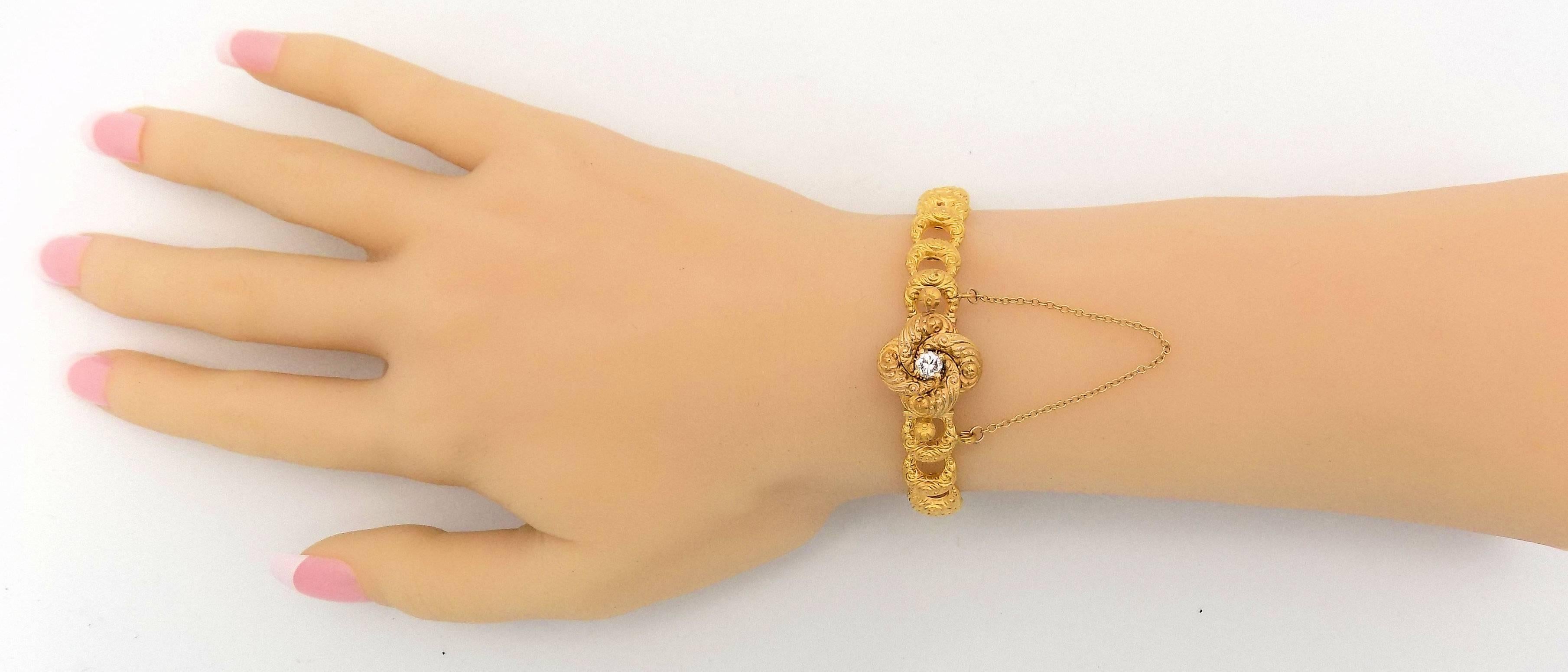 14 Karat yellow gold crescent link bracelet with center diamond.  Manufactured by Krementz, a firm that was in business a hundred years ago.  They were best known for gentlemen's accessory jewelry.  

This lovely bracelet is heavily repoussed
