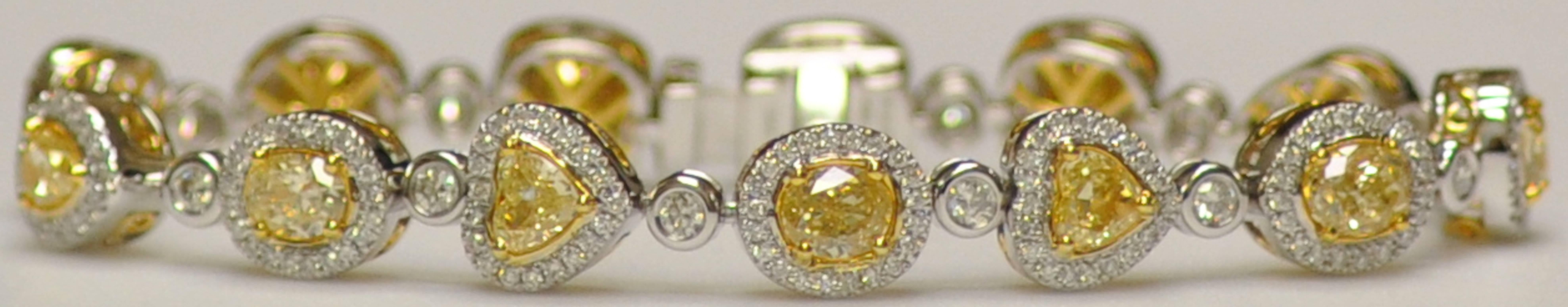 A lovely bracelet by Yael Jewelry based in California.  It has 13 yellow diamonds: radiant, oval, pear shape and heart shape weighing 7.59 carats total.  Surrounding each yellow diamonds are small white round diamonds totaling 2.72 carats.  Diamond