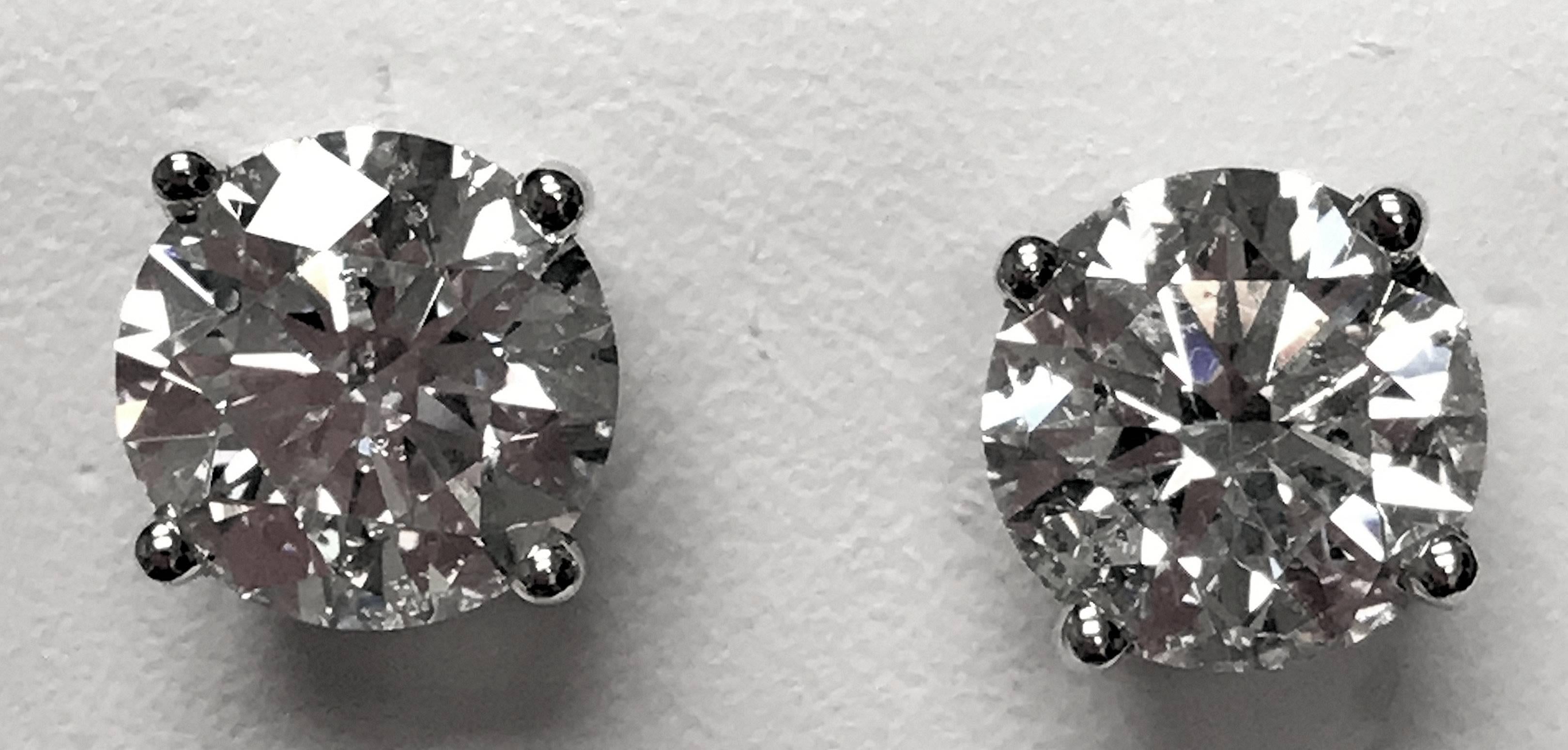 Well-cut and matched round diamond set in basket style ear studs. Clarity is I-1, and color is J.  These are bright lively stones that are very brilliant.  1.5 DWT. 