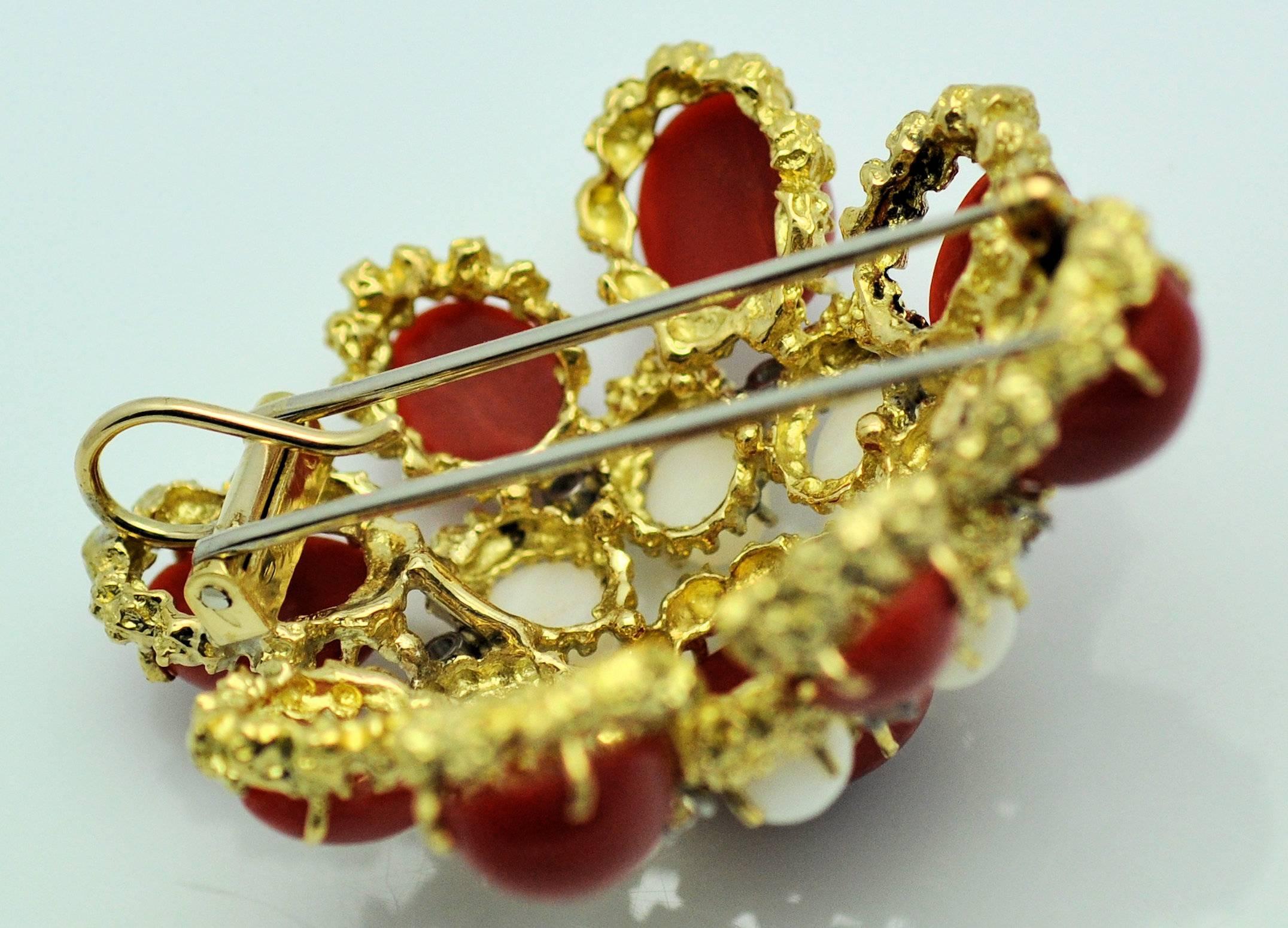A lovely mid-century piece of textured jewelry capturing the best of the period.  Fine white and deep red coral stones and fine round diamonds.  This piece can be worn as a brooch with double prong clip-hinge or added to a gold necklace to make a