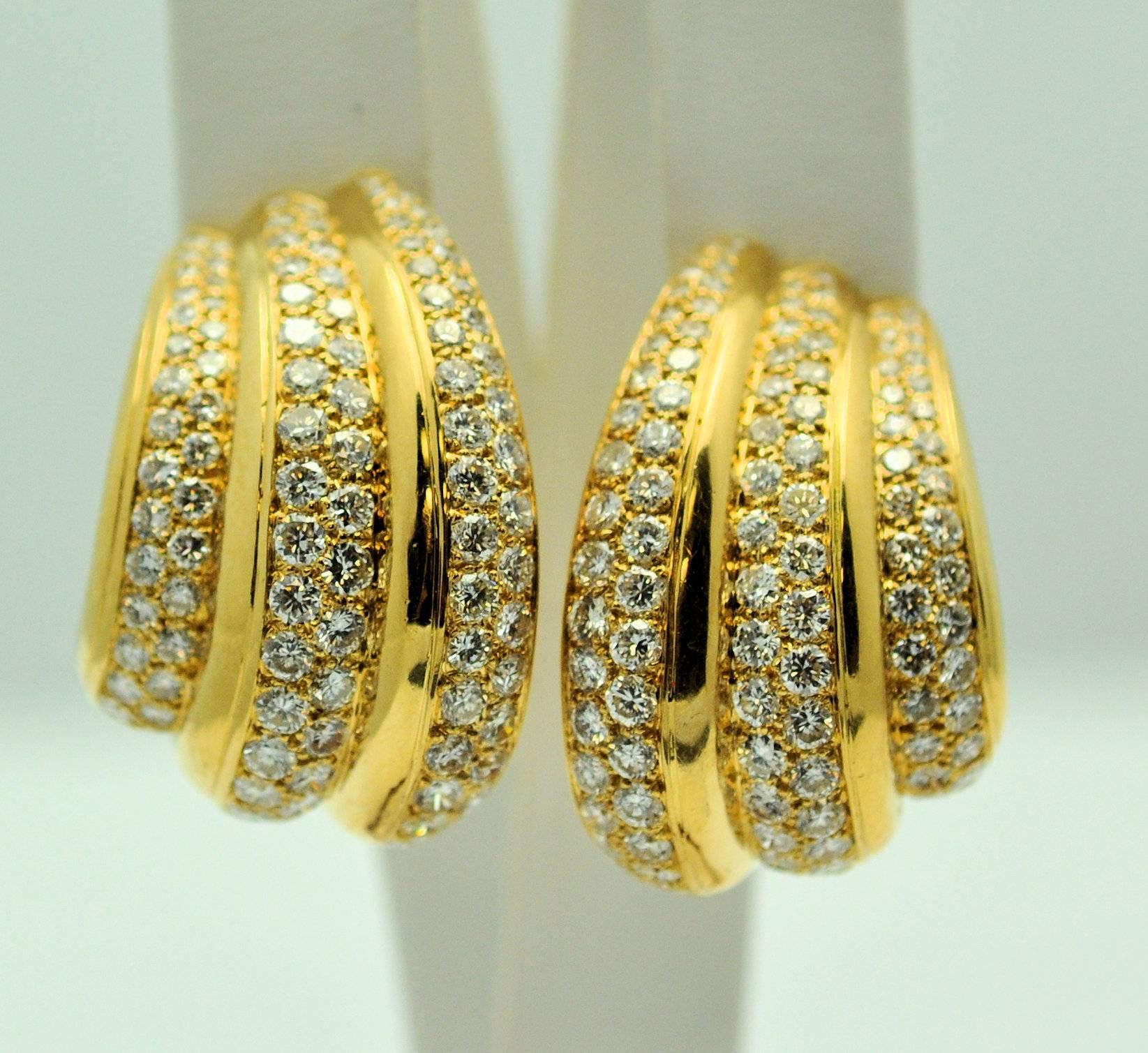 Large and lovely pair of Van Cleef and Arpels triple row pave diamond earrings, pierced/clip.  18Karat yellow gold and set with 294 round brilliant cut diamonds approximately 10.00 carats of grade VS-1, G.  Signed VCA #57260 NY. 16.6 DWT.
