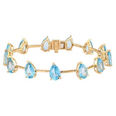 Tennisarmband aus 925er Sterlingsilber mit vergoldeten blauen Topasen im Birnenschliff