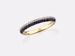 Anillo de oro amarillo de 14 quilates con banda redonda entrecruzada y diamantes