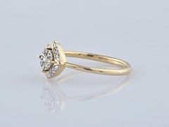 Anello con diamante taglio rotondo da 0,10 ct in oro giallo 14 carati con montatura a halo