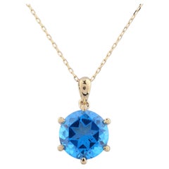 Collana con ciondolo solitario in oro giallo 14 carati con topazio blu svizzero rotondo, montato a 6 griffe