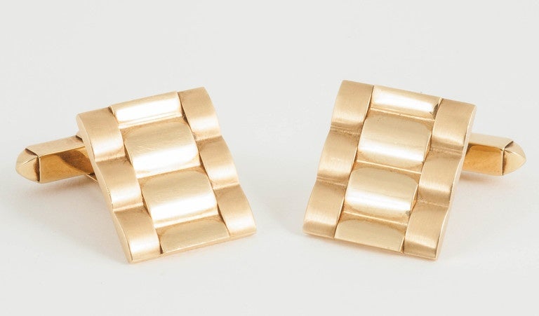 A heavy pair of 18ct gold [hallmarked] single sided cufflinks of Rolex bracelet design in brushed and polished form. Date for 1986 with Kutchinsky mark.
