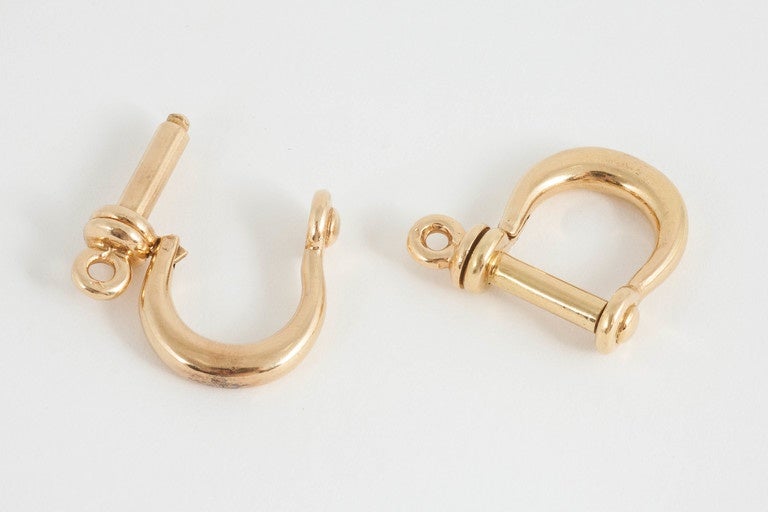 A heavy pair of finely made cufflinks in the form of boating Shackles,the bend of the shackle worn around the outside of the cuff. French, marked with eagle's heads. Circa 1960.