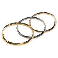 A Set of Tri-Colored Gold 'Love' Bangles by Cartier