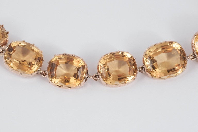 This stunning graduated cushion cut Citrine necklace is in a cut down setting of 15ct Gold.