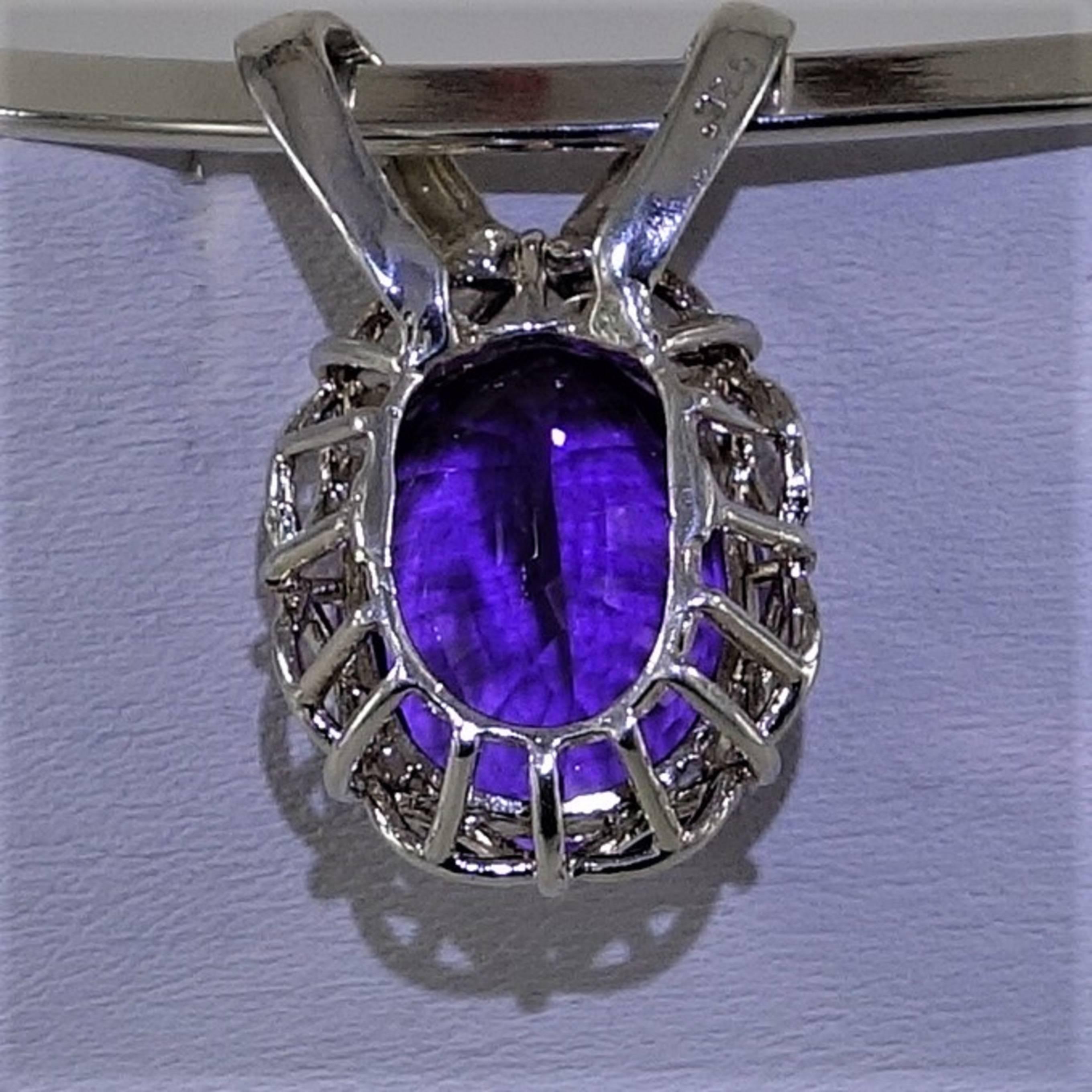 Sterling Silver Pendant with Amethyst. Sprarkling, Step cut Brazilian amethyst of 20.30 carats set in Sterling Silver. The setting has two large bails to accommadate a chain or collar.  The setting itself is a basket that raises up to marquis shapes