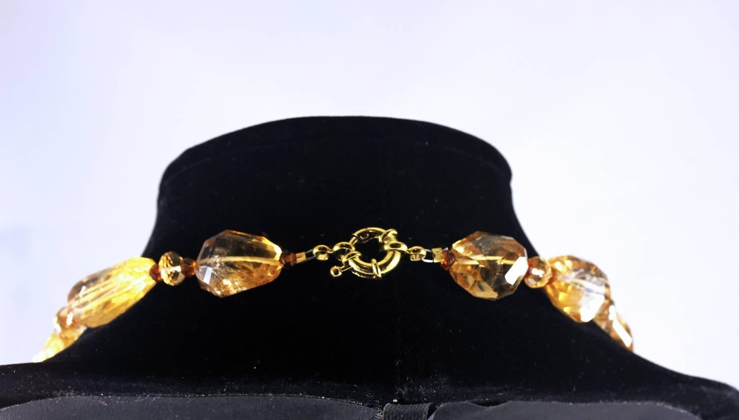 Highly polished chunks of Citrine honey color gemstones enhanced with gem cut sparkling smaller Citrine and Spessartite Garnets complete this beautiful almost choker style necklace..
Size:  graduated to approximately 22 mm x 13.5 mm