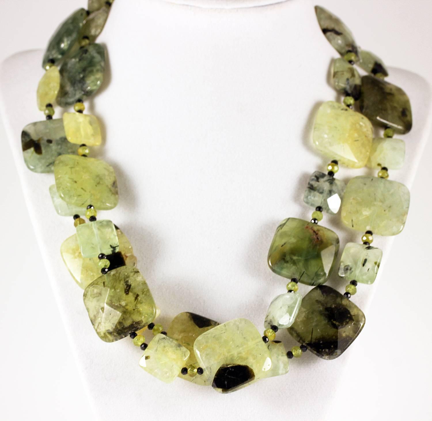 Double strand of translucent glowing natural chunks of checkerboard gem cut Prehnite enhanced with little sparkling Peridot gems and sparkling black Spinel.
Size:  large Prehnite approximately 25 mm x 25 mm
Length:  19 inches
Clasp:  gold plated
