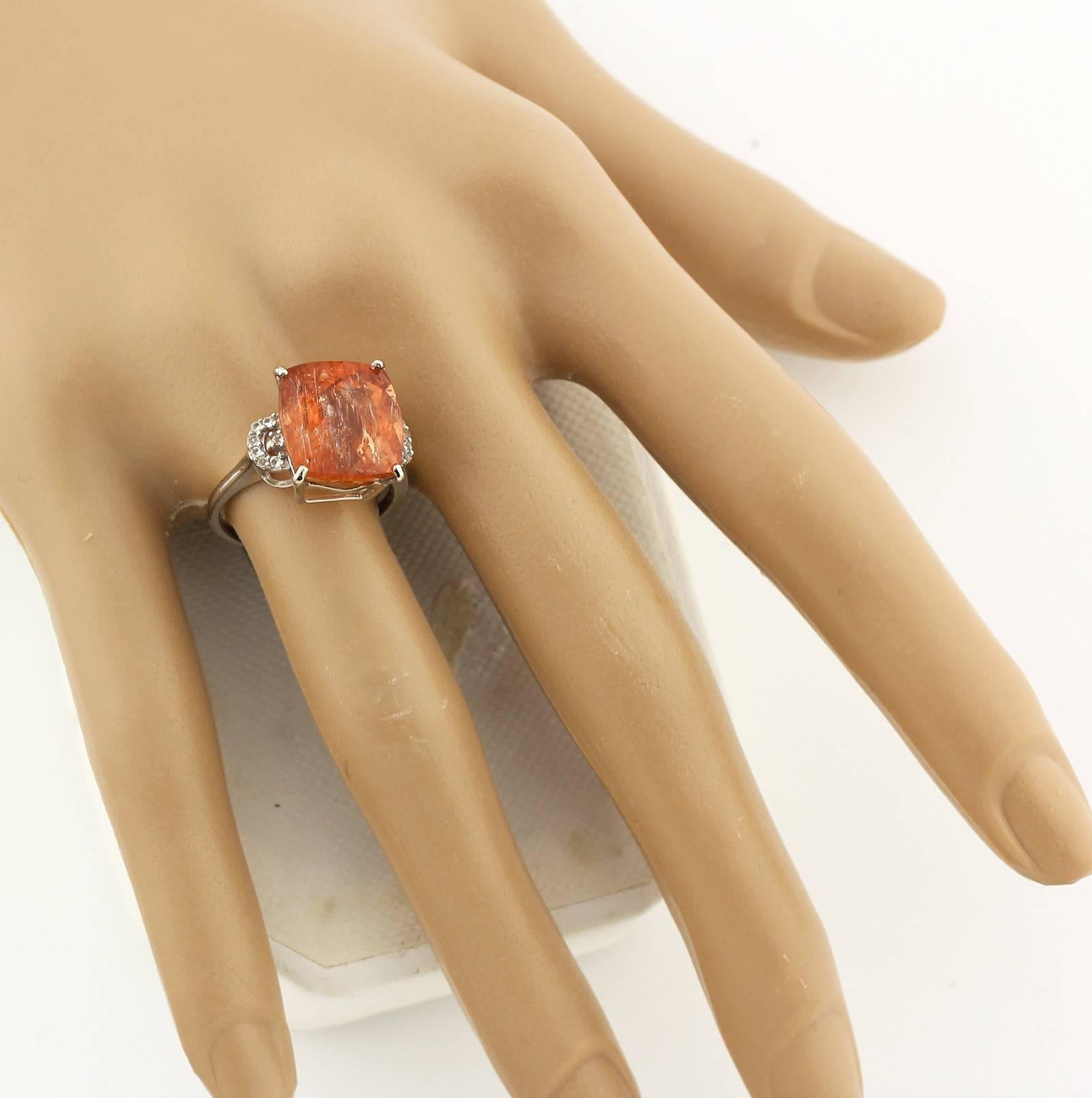 Exceptionally glittering brilliant 8.2 carats of natural cushion checkerboard cut Brazilian Imperial Topaz straight from the historic mine of Minas Gerais.  It is enhanced with sparkling white Brasilian Topaz set in this unique handmade Sterling